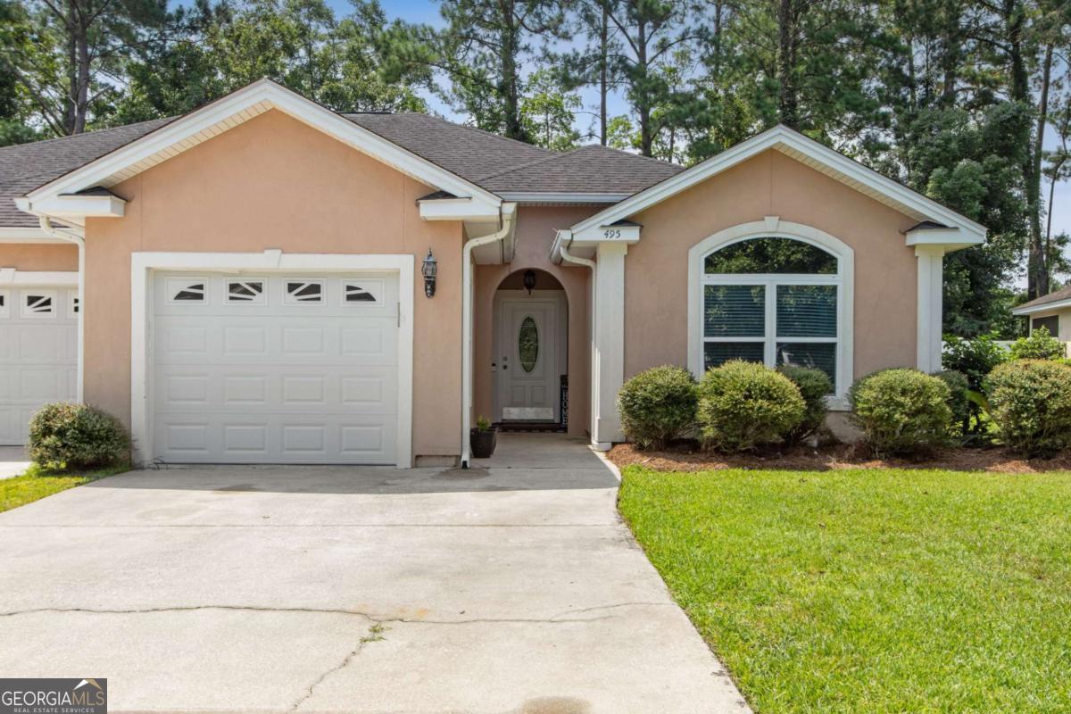 Welcome to relaxed, low-maintenance living in the highly sought-after Laurel Island Plantation community-home to a stunning 18-hole championship golf course designed by Davis Love III. This golf course community offers a full service bar and grill, playgrounds & golf cart access to all amenities. This thoughtfully maintained 2-bedroom, 2-bathroom home spans 1,398 sq ft and was built in 2005 with comfort and style in mind. Step inside to a open living area featuring tray ceilings and natural light, setting the tone for an inviting space. The kitchen is a chef's delight with custom wooden cabinetry, stainless steel appliances, and a layout perfect for both everyday living and entertaining. This home offers a split floor plan perfect for a roommate situation. Retreat to the spacious primary suite, where vaulted ceilings, a soaking tub, tiled walk-in shower, and double vanity create a luxurious, spa-like atmosphere. The second bedroom features charming arched window details and is conveniently located near the second full bath-ideal for guests or a home office. Enjoy peaceful Southeast Georgia evenings on the screened-in back porch, perfect for unwinding or entertaining. The paved driveway and automatic garage door add everyday convenience. Located just minutes from I-95, shopping, and restaurants, this home offers easy access to FLETC (30 minutes) and Jacksonville International Airport (35 minutes)-making it perfect for commuters or anyone seeking the ideal blend of comfort and convenience. Don't miss your chance to enjoy resort-style amenities and a vibrant community lifestyle-schedule your private showing today!