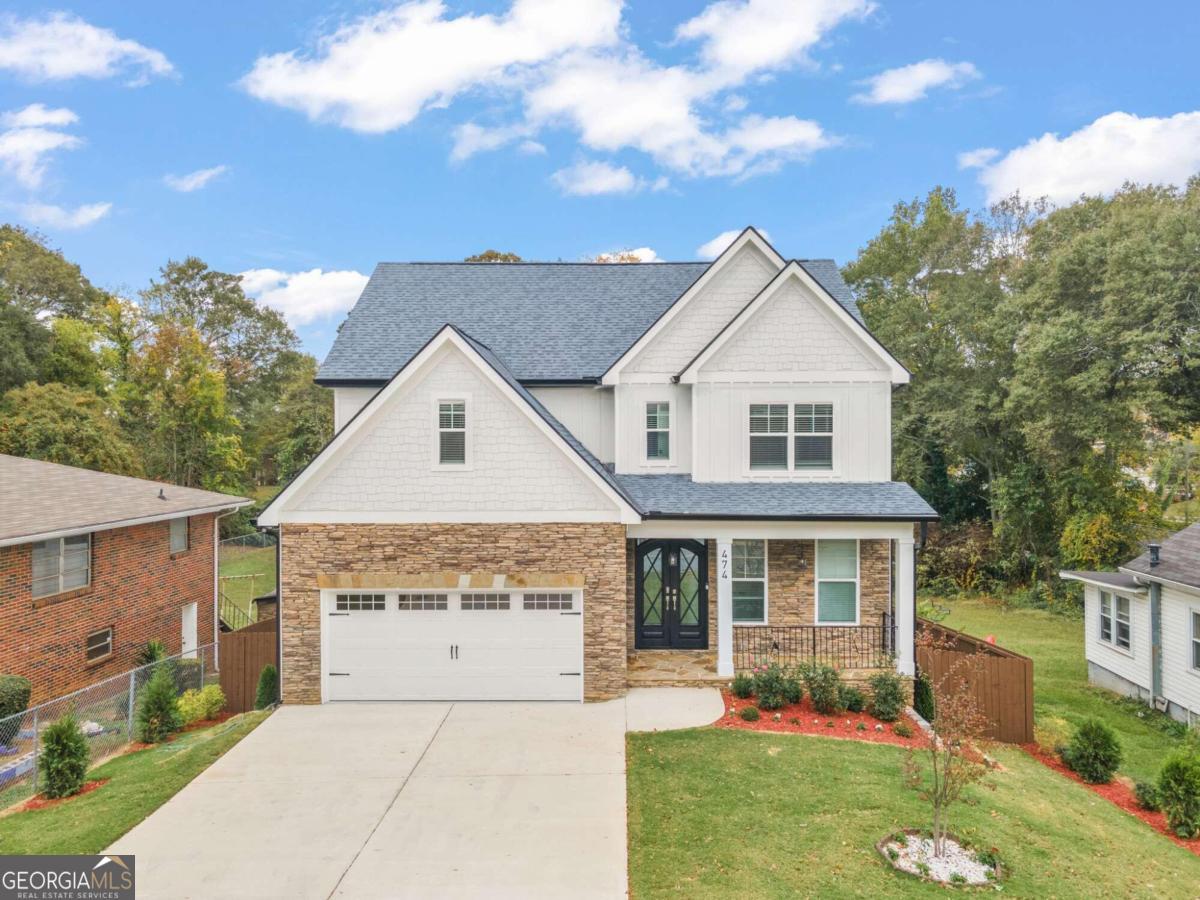 Stunning New Construction Near Marietta Square! Discover luxury and convenience in this brand-new construction home located just moments from the vibrant Marietta Square! This 6-bedroom, 4.5-bath quality built home with designer touches is move-in ready and offers timeless elegance in a charming, transitioning neighborhood that combines character and modern amenities. Key Features: Main Level Comfortable Elegance, Custom Entry: Double wrought iron doors make a striking first impression. Gourmet Kitchen: Designed to inspire, featuring quartz countertops, a stylish backsplash, oversized island, walk-in pantry, and brand-new LG stainless steel appliances. Two-Story Great Room: Designer wood ceilings and oversized windows flood the space with natural light, creating an inviting and relaxing atmosphere. The indoor to outdoor living experience is bar none! Featuring A Covered Deck: Enjoy peaceful outdoor living with double ceiling fans, perfect for entertaining or unwinding. Overlooking the large spacious, fenced backyard. Primary Suite on Main: A luxurious retreat with a spa-inspired en-suite bathroom, including double vanities, a freestanding soaking tub, a separate shower, and custom walk-in closet shelving. Second Floor Sophistication, Open Loft Space: Overlooking the living room, ideal for a reading nook or additional lounge. Three Spacious Bedrooms: All with large, custom walk-in closets. Additional Storage: Convenient hallway storage for extra functionality. Fully Finished Terrace Level: In-Law Suite or Home Office: Includes a second full kitchen with new appliances, second laundry room, two spacious bedrooms, and a large entertainment space. Enhanced Comfort: Double-insulated walls for sound and temperature control. Additional Upgrades: Solid hardwood floors throughout with elegant 8" baseboards. 8-foot exterior doors for a grand architectural touch. Three HVAC units and a tankless water heater for energy efficiency. Irrigation system for easy lawn maintenance. Fully fenced backyard with endless possibilities Co perfect for a future pool or gazebo. One-year home warranty included for peace of mind. Prime Location: Situated in the heart of a walkable community near Marietta Square, this home offers easy access to an array of local attractions: City Club of Marietta, Cobb County Civic Center, The Aquatic Center, Kennesaw Mountain, shopping, dining, and cinemas! Quick connections to I-75 and I-285. This remarkable home offers a rare opportunity to enjoy modern luxury, thoughtful design, and a thriving location. With NO HOA and unmatched convenience, this property is the perfect place to call home.