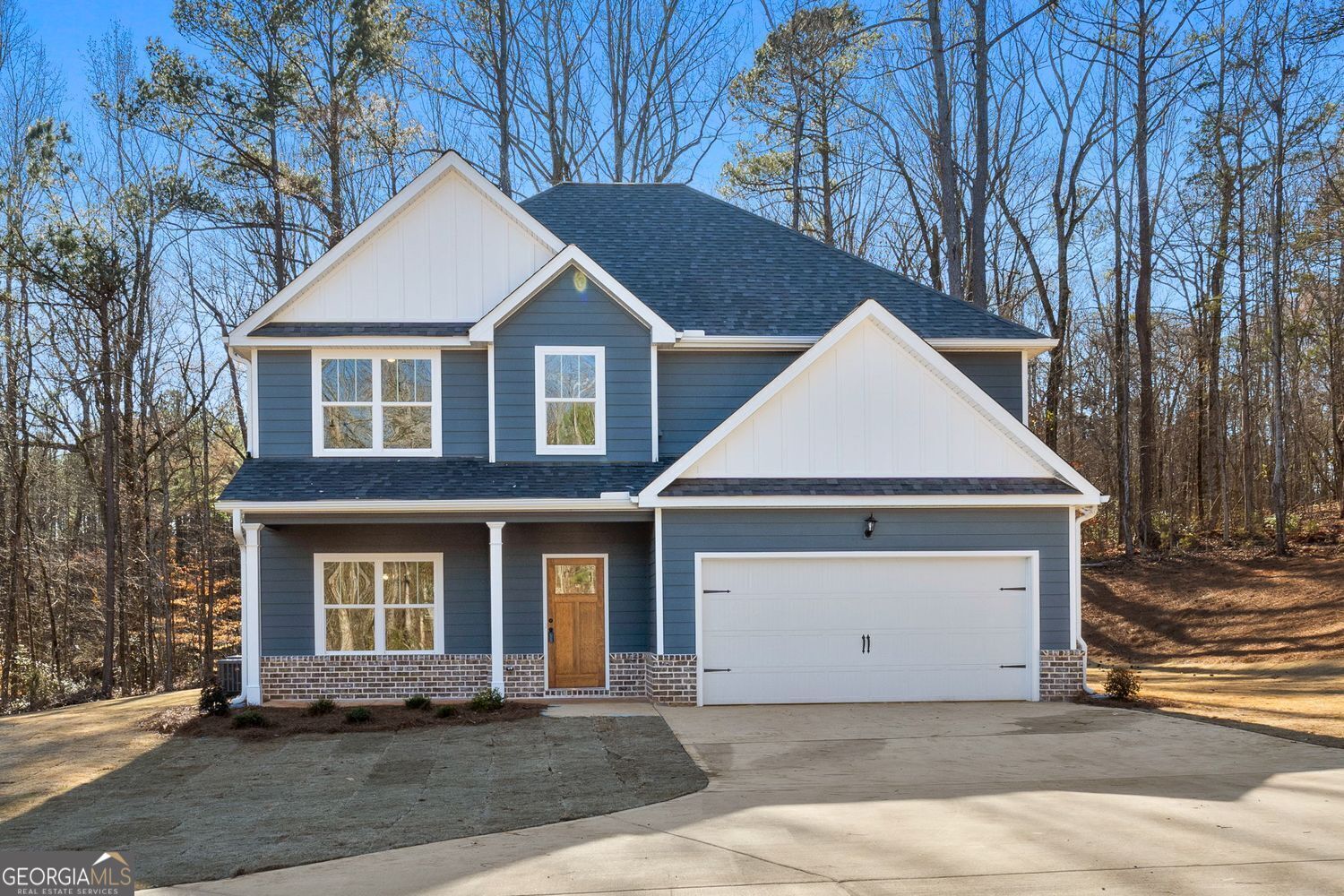 Here's your private place to spread out in sought after Forsyth, GA (Monroe County)! Located in North Forsyth off of the Johnstonville Road exit. Brand new construction offering 5.4 +/- acres and over 2,500 square feet of living space in this 5 bedroom/3 full bath home! Enter through a formal foyer entry to find a formal dining room with decorative beams and trim work - it's perfect for formal dining or can be utilized as a great flex space (home office, etc). The kitchen features an island with breakfast bar, an informal dining area, pantry, stainless steel appliances, and granite countertops. The family room is spacious and offers a real wood burning brick fireplace with gas starter, rustic wood mantle and shiplap accent. The family room offers access to the large covered back porch with a rustic wood planked ceiling for additional entertainment & outdoor living space. The 5th bedroom/guest room is located on the main, along with a full bath to service the bedroom and guests. The main floor offers LVP flooring throughout. Upstairs you'll find a huge and private primary suite with soaring ceiling and a spacious bathroom featuring a tile floor, dual sink vanity with granite countertop, soaking tub with tile surround, an oversized fully tiled shower with glass door, and a big walk-in closet! The secondary bedrooms upstairs all offer walk in closets. There's a spacious laundry room too! This home has a brick water table on the front and sturdy Hardie siding on all sides. Two car garage with automatic openers. Covered front and rear porches with wood planked ceilings. The rear porch has a covered an uncovered portion for grilling. Situated on over a beautiful 5.4 +/- acre lot with sodded yard space and the rest in woods for nature and privacy lovers. The driveway is long and winding and the home sits back off the road. No HOA or restrictions here! Less than 5 minutes from I-75, yet you'll feel like you're away from it all, making this a slam dunk for commuters. Convenient to the quaint downtown Forsyth square, where there are many great local small businesses and restaurants and many local community events are held. Gas, grocery, shopping and dining are all less than 10-15 minutes away as well. Sought after Monroe County school system (KB Sutton Elementary, Monroe Middle, and Mary Persons High School). Use the preferred lender and receive 1% of your loan amount back towards closing costs and/or interest rate buy down. Home is nearing completion and can be closed in less than 30 days. Builder supplies a 2/10 home warranty at closing at no cost to purchaser!