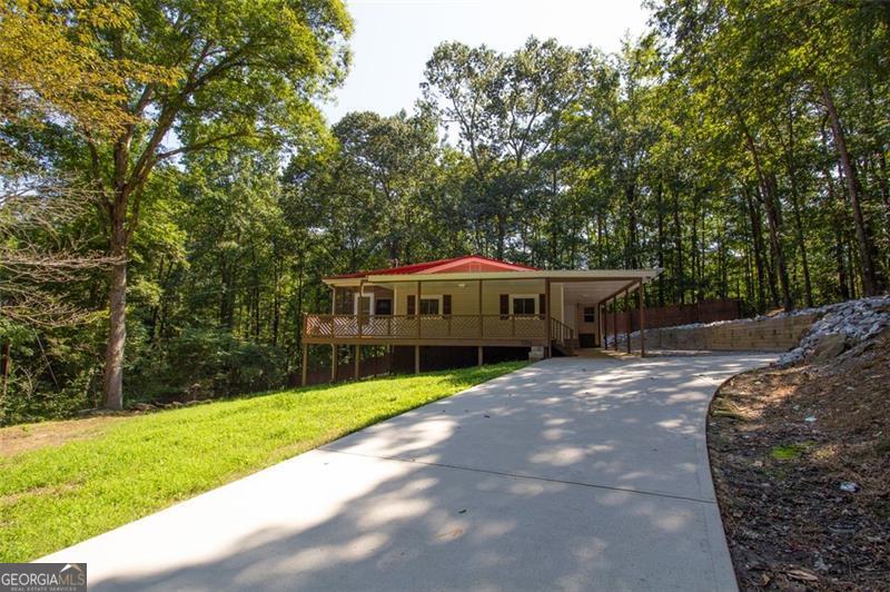 Your mountain retreat in the city!! This home is incredibly private at the end of a quiet tree lined road in a cul-de sac type setting. Mature trees surround this fully fenced property. The seclusion fosters the feeling of being in North Georgia Mountains. The house boasts two bedrooms, one bath, country kitchen with laundry room and pantry space. Large deck and single carport. This home has been well maintained complete with new driveway, waterproofing, French drains and metal roofing. Great place for fur babies- away from busy streets! Minutes to Atlanta Airport, I-285, I-75 and I-85 and only 20 minutes from downtown Atlanta. VRBO? No problem. Property is believed to be in great condition and has been meticulously maintained but buyer should be advised that it is being presented "as is".