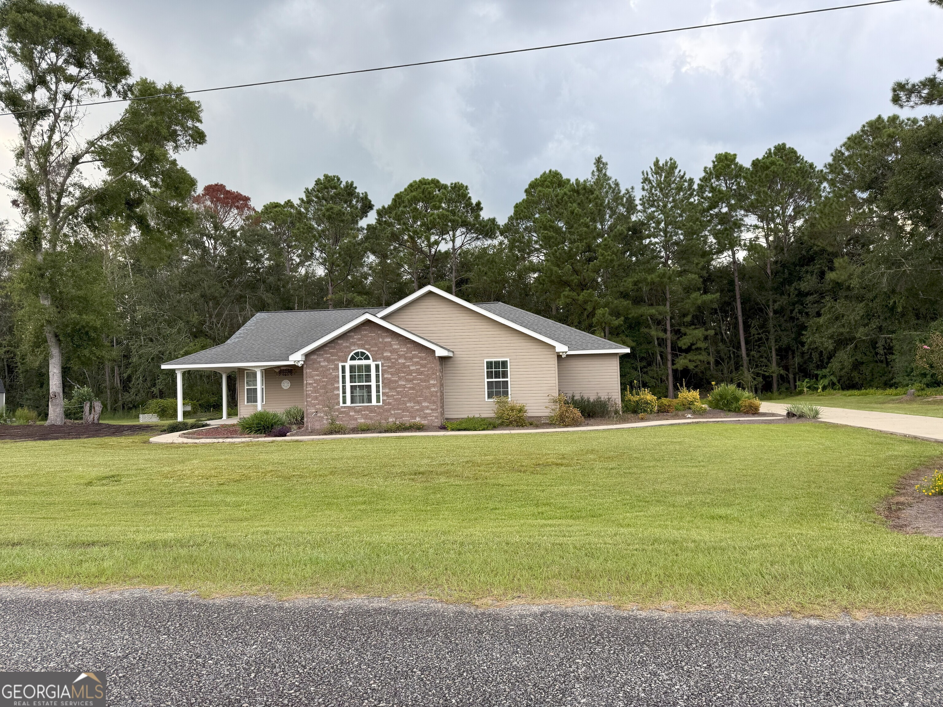 Spacious 2 bedroom/2bath home built in 2014 on approx 1-acre lot in Oak Ridge subdivision! City water. Open Kitchen/dining/living room also has an eat-in kitchen bar and feels huge with the high-vaulted ceiling! Stainless steel appliances. TONS of kitchen cabinets & even MORE in the large laundry room, as you enter from the double garage! Main bedroom will host your king-size bedroom suit! Features walk-in closet. Main bathroom features a claw-foot tub, dual sink vanity, separate shower, and quaint chandelier. Wooden deck. Fantastic vinyl fencing in the back yard and at entrance. Lots of concrete for parking & walking around the home. Move-in ready! Call Jessica Carver today at James M. Swain & Assoc., Inc. for a showing this weekend! 229-375-4258 (cell) or 912-367-3601 (office).