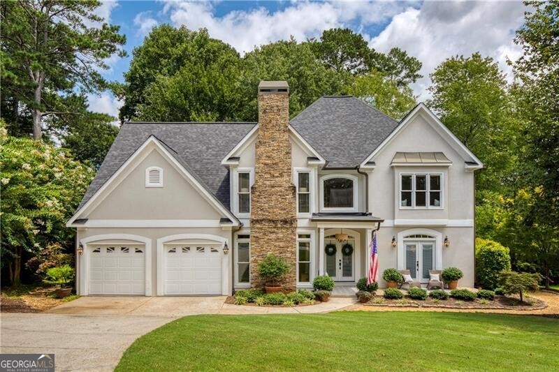 Impeccably maintained by the original owners and perfectly positioned on a quiet cul-de-sac in sought-after Hillbrooke, this beautifully updated 5-bedroom, 3-bath home blends timeless style with modern functionality. Recent upgrades include a NEW roof (August 2025), NEW windows and doors, and a recently painted Hardie Plank exterior with hardcoat stucco front. It's the largest floor plan in the neighborhood and it's totally move-in ready! From the welcoming front porch to the serene backyard oasis, every detail has been thoughtfully designed for comfort, connection, and easy living. Step into the sunlit two-story foyer, where neutral paint and wide-plank LVP flooring create an inviting flow. The open floor plan is anchored by a chef's kitchen featuring crisp white cabinetry, granite countertops, double ovens, a subway tile backsplash, under-cabinet lighting, hidden outlets, and a generous casual dining area. A walk-in pantry keeps everything organized. AND GOOD NEWS - an existing gas line and capped downdraft in the island offer the option for easy install of a future gas cooktop with downdraft. The kitchen opens to a vaulted great room with surround sound, a wall of windows, and a cozy fireplace-perfect for gatherings. French doors lead to a bright sunroom overlooking the lushly landscaped backyard. It's a tranquil sanctuary full of perennials so you can just relax and watch them grow while you enjoy your morning coffee! A formal dining room, a separate sitting room/office with French doors, and a main-level guest suite (or private office) with a full bath provide flexibility for modern living. Upstairs, the oversized primary suite is a true retreat with a vaulted ceiling, sitting area with fireplace, and a spa-inspired, fully-renovated bath featuring a frameless glass shower, standalone soaking tub, dual vanities, and barn doors opening to an expansive walk-in closet with off-season storage. Three spacious secondary bedrooms share an updated hall bath with dual sinks, while a flexible loft offers space for a workout area, gaming zone, or reading nook. Outside, the private, level backyard is a showstopper-meticulously landscaped with easy-care perennials, dry riverbeds, winding pathways, and tranquil sitting areas. Multiple gathering spots, including a patio, firepit, outdoor dining space, and lawn, make it ideal for entertaining, play or relaxing. The 2-car garage offers insulated doors, and the spacious laundry/drop zone off the garage includes a soaking sink and extra storage. Hillbrooke residents enjoy swim/tennis amenities, a welcoming community atmosphere, and a prime Johns Creek location close to top schools, parks, Medley Johns Creek (coming soon), Avalon, Halcyon and other area shopping and dining. It's no wonder U.S. News & World Report recently recognized Johns Creek as the #1 Place to Live. Don't miss the magic!