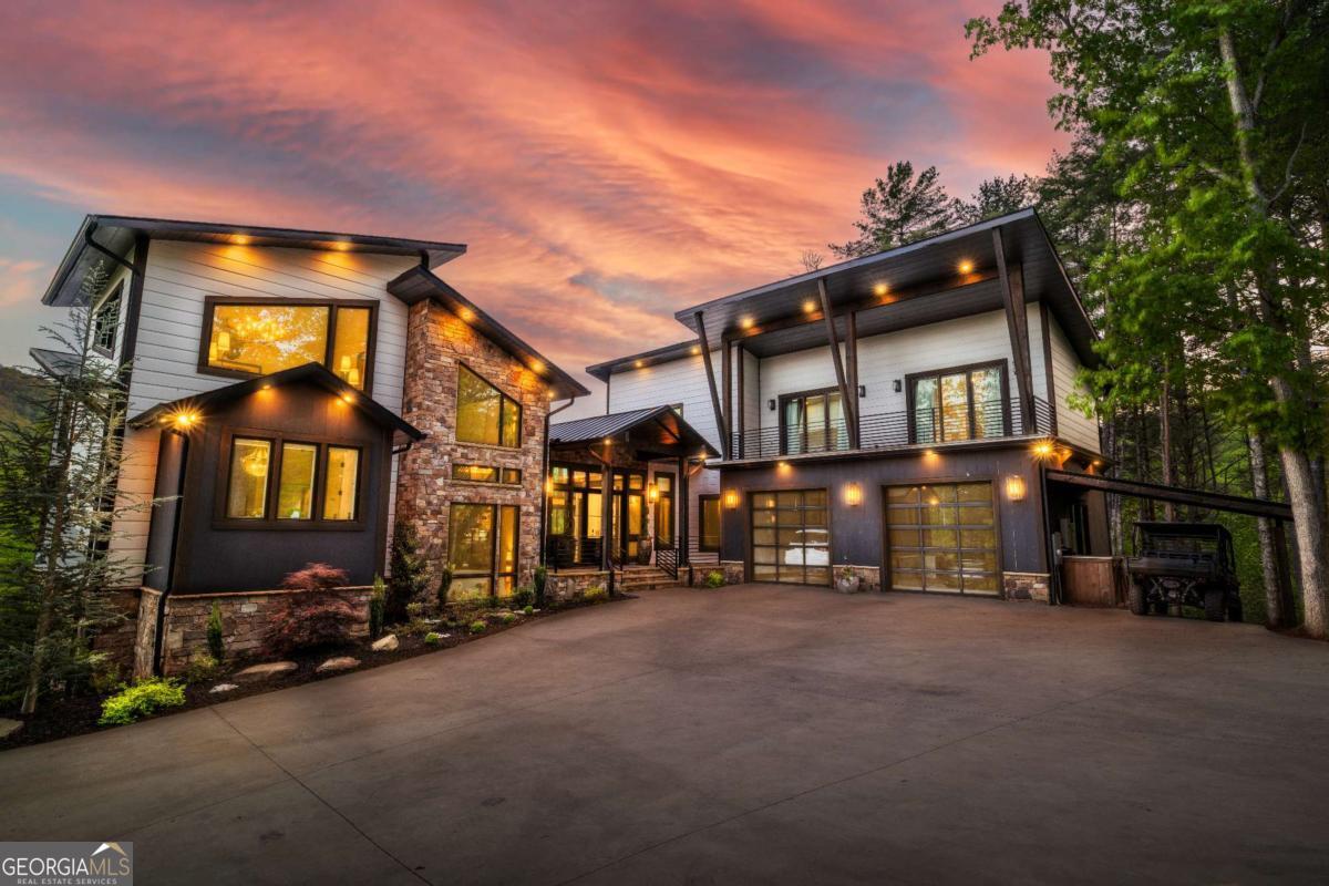 Welcome to an unprecedented world of luxury & tranquility at this bespoke estate, meticulously crafted to blend the rustic allure of a Montana chalet w/ the serene elegance of the Blue Ridge Mountains. Located only 7 minutes from downtown, yet enveloped in 10 acres of absolute seclusion, this property offers an unparalleled living experience. As you approach, be mesmerized by the lush, landscaped grounds that frame the fully paved entrance. Here, a breathtaking elevation captures both modern aesthetics & rustic charm through the seamless integration of carefully placed lighting, steel beams, and exquisite Windsor windows. This harmonious blend of elements sets the stage for the luxury that awaits inside. Step through the grand entrance into a sprawling open floor plan that highlights captivating views from every angle, framed by floor-to-ceiling glass that invites natural light to dance across the interiors. The primary suite is a sanctuary of indulgence, featuring a contemporary fireplace, dual walk-in closets, & a lavish steam shower, providing a private retreat within the home. On the opposite wing, the guest accommodations promise comfort & privacy with two expansive ensuite bedrooms with a large private balcony. The lower level is a hub of activity & relaxation, featuring an in-home gym complete with a built-in sauna, guest quarters, & an innovative bunk room. The space transitions effortlessly to a party deck via custom garage doors, where an infinity pool w/ a hot tub await, offering awe-inspiring views of the estate's pastures & the majestic mountains beyond. Other features include a screened-in meditation den, providing a peaceful escape, & a 3-bay oversized garage/shop w/ both electric & plumbing. For those seeking a functional yet elegant lifestyle, the estate features an operational farm w/ three barns & a running stream. Experience the epitome of luxury living in a serene mountain setting with this extraordinary unique estate.
