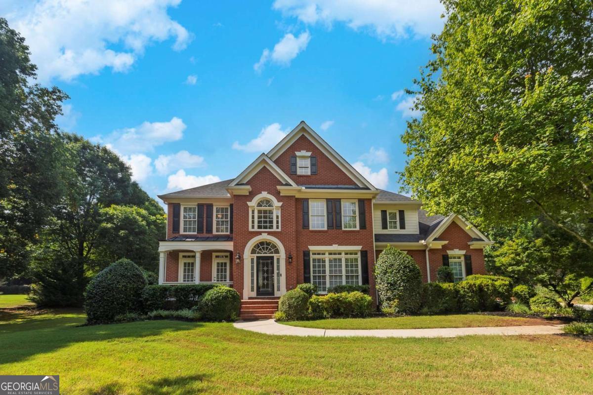 Charming and impeccably cared for traditional home located in the top rated and highly sought after Cambridge High School district in Milton! This beautifully maintained 5 bedroom, 3.5 bath home perfectly positioned on a private lot with 1 acre that offers the perfect balance of spacious living and modern elegance, all nestled in a peaceful and quiet neighborhood. As you arrive you are welcomed with lush grass, thoughtful landscape and impressive curb appeal, inviting you for awaits inside. Enter inside where you instantly feel at home with a 2 story foyer, sleek hardwood floors and the perfect amount of natural sunlight throughout. Just off the 2 story foyer includes French doors leading into the perfect home office space with views to the scenic front yard and private access to the front porch. Adjacent from office is a oversized formal dining room that is connected to the heart of the home eat in kitchen featuring, white cabinetry, wall oven and microwave, stainless steel dishwasher and fridge, spacious pantry, butlers pantry, breakfast bar and the perfect space for a coffee bar. Eat in kitchen offers easy access to a half bathroom and opens up to a lovely living room with a gas fireplace and coffered ceilings making gatherings and entertaining easy and seamless. Upstairs includes the stand out oversized primary suite with tray ceilings, a roomy seating room perfect for early mornings and relaxing evenings. Primary suite has its own spa retreat bathroom with tall vaulted ceilings, dual vanities with granite countertops and ample storage, spacious shower, free standing tub, water closet and tiled floors with an attached spacious primary closet with built in shelving. Upstairs also includes, 4 spacious bedrooms with deep closets, 2 full bathrooms with tub/shower combos and a spacious laundry room with wired shelving, storage cabinets and a utility sink. Outside, enjoy your morning coffee or evening glass of wine on the spacious patio off eat in kitchen surrounded by lush, mature landscaping. Practical meets style with the 3 car garage with built-in cabinetry adds functional storage and extra versatility. Just minutes from Avalon, Halcyon, Bell Memorial Park, Crabapple Market, North Park, Windward Parkway, and vibrant downtown Alpharetta that is filled with local coffee shops, farmers markets, evening concerts and the best eats in town, with GA 400 close by for an easy commute and endless weekend plans. This incredible home is officially seeking its new owner! Showings start Thursday, August 7th.