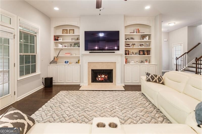 Welcome to Grove Park! The low-maintenance lifestyle you've been looking for awaits you in this beautifully landscaped Active Adult 55+ community just minutes from Marietta Square. This is the Magnolia floor plan, the largest and most sought-after floor plan in the community. The bright and open layout is very inviting and a perfect place for entertaining friends and family. Enjoy one level living plus a large 2nd-story bonus room! This home features a coveted screened-in back porch overlooking some green-space and private woods! Beautiful hardwood floors are further complimented by tall ceilings, a spacious kitchen with tons of prep space, white wood cabinets, stainless steel appliances + huge walk-in pantry. You'll love all the finished storage space on the main level and upstairs. All exterior building/roof maintenance and yard maintenance included in your monthly HOA dues + water/trash/sewer! Grove Park features gated access and a beautiful Clubhouse with catering kitchen, gym, and library; a swimming pool; a dog park; a composting area; and walking paths throughout the community. In addition to loving your turn-key home, you will love the convenience to the dining, entertainment, and attractions of Historic Marietta Square (10-minute drive!). Plus, you can take advantage of the proximity to hiking trails around Kennesaw Mountain or go shopping at The Avenue West Cobb! This home has barely been lived in and shows like a model home, impeccably maintained and move-in ready for you!