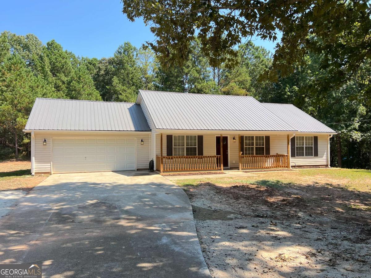 Updated 3BR/2BA Ranch on 1 Acre in Quiet Covington Cul-de-Sac! Move-in ready with renovated all-electric kitchen, new cabinets, and stainless steel appliances. Fresh paint and LVP flooring throughout-no carpet! Spacious living room with high ceilings and fireplace. Master suite with separate tub/shower. Expanded driveway for extra parking, plus 2-car garage with storage shelves. Septic recently serviced/pumped. Peaceful, no-HOA neighborhood. Don't miss this one! FHA financing will be accepted after the 90 day seasoning period is over on 9/29. Fridge or washer/dryer combo with full priced offer closing within 30 days!