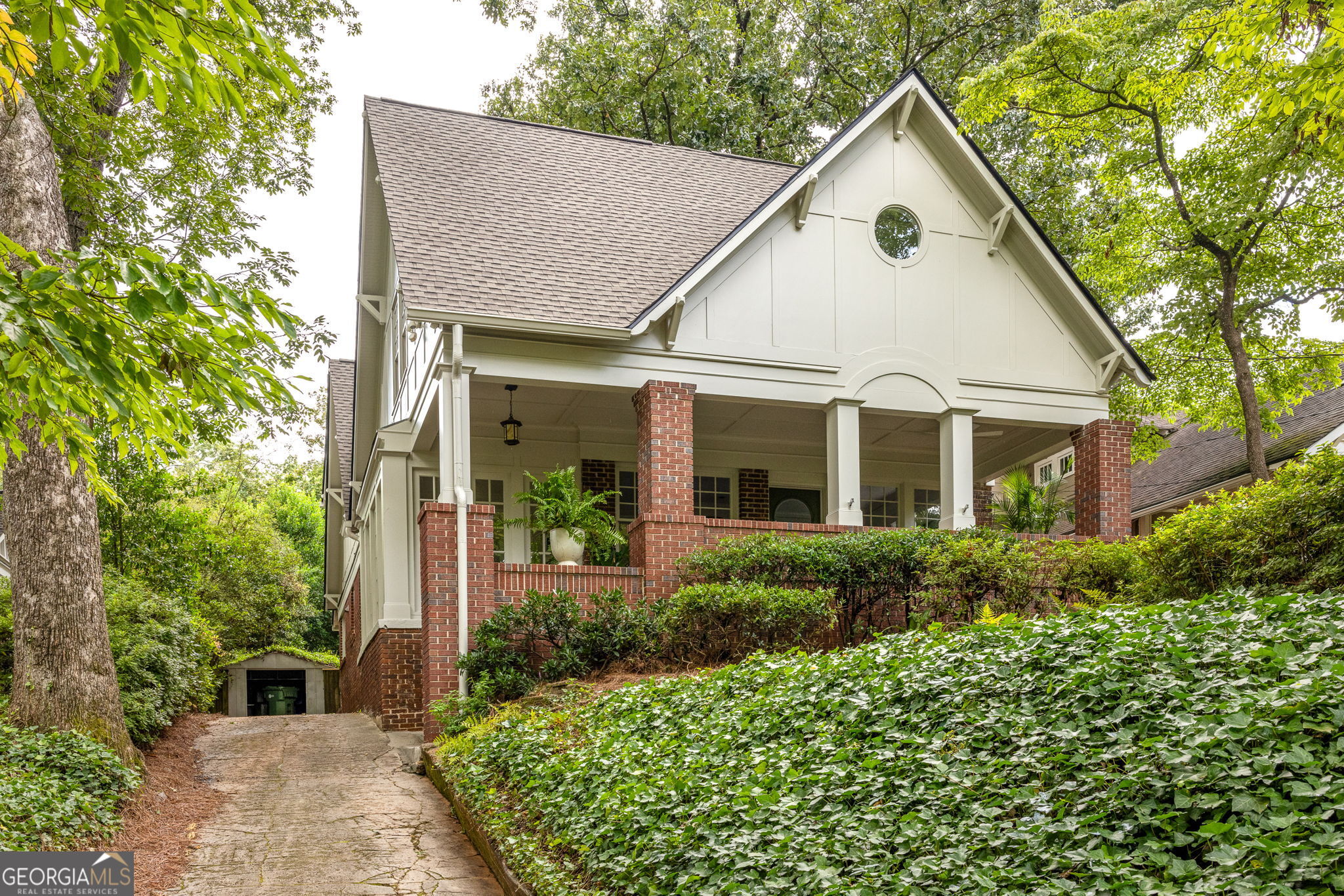 Some homes are built to impress. Others are built to live in. This one does both - with grace, light, and historic charm. This classic Morningside Tudor combines original vintage character with a fresh, modern sensibility. Perfectly placed on one of the neighborhood's most beloved streets, this sun-drenched, character-filled home blends timeless architecture with smart, stylish updates throughout. Originally designed by Lelia Ross Wilburn - Atlanta's first female architect - its thoughtful layout, rich detailing, and beautiful proportions still shine, now paired with a long list of functional upgrades that make everyday living feel easy. A deep, breezy front porch sets the tone, complete with multiple seating areas for those summer nights and neighborly conversations. Inside, the main level opens with a formal living room and picture molding details that whisper back to the home's heritage. A cozy sunroom wrapped in floor-to-ceiling windows makes the perfect reading nook or creative corner, while a separate dining room and light-filled breakfast nook offer space for both everyday meals and full-on dinner parties. The heart of the home is a large, open living space at the back, where French doors open to a walkout backyard, ideal for outdoor hangs, easy hosting, or simply enjoying some sunshine. Also on the main level is a private guest suite with a fireplace and full bath, ideal for visiting family, live-in assistance, or that home office that finally gets some dignity. Upstairs, the landing opens to a flexible lounge space - think reading area or a cozy second den. The primary suite is a true retreat, with natural light, beautiful views, a spacious walk-in closet, and an ensuite bath complete with a cast iron soaking tub, dual vanities and a separate shower. Two generously sized secondary bedrooms each feature large closets and share access to a sunny bonus room that works hard for whatever you need. A dual-sink hall bath adds function and shareability, and in its own private space windows make even laundry feel luxurious. This is the kind of home that evolves with your life-offering character, comfort, and the kind of layout that just works. And with its location in the heart of Morningside, you're just moments from parks, shops, restaurants, and everything that makes this neighborhood one of Atlanta's most beloved.