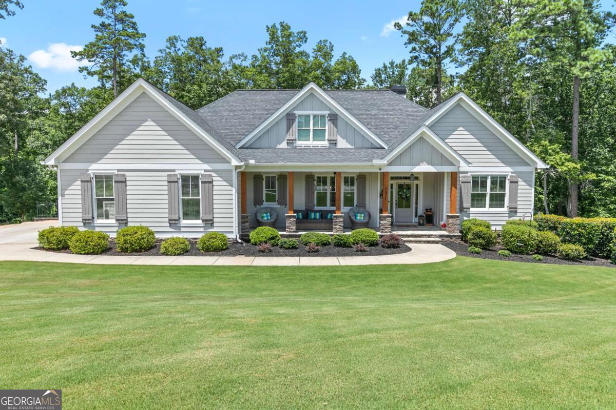 Take a look at this stunning, custom-built ranch home tucked away on a private cul-de-sac in beautiful Cherokee County! Situated on over an acre of meticulously maintained land, this home offers a peaceful setting with a level driveway and an oversized garage that can even accommodate a boat. Step inside to an open concept layout filled with natural light, featuring cathedral ceilings with cedar beam accents in the spacious family room, fresh interior and exterior paint and gleaming hardwood floors throughout. The chef's kitchen is the heart of the home with a large island, gas cooktop, ample cabinetry, walk-in pantry, and stainless-steel appliances. The oversized owner's suite on the main level includes two custom walk-in closets, and a spa-like bath with dual vanities, granite countertops, and a large centered soaking tub. Enjoy cozy evenings on the screened-in porch with tongue-and-groove ceilings and an outdoor stone fireplace-perfect for relaxing or entertaining year-round. Downstairs, the terrace level has been transformed into the ultimate entertainment zone, complete with a large rec room, full bar, game TV area, home gym, full bath, and a private bedroom with a full bathroom. You'll also find a workshop, safe room, tons of storage, and a huge unfinished space ready for your personal touch. Step outside to the covered terrace-level deck with a hot tub and admire the peaceful wooded backyard and stone firepit gathering area. A great place to entertain friends and family. This hidden gem offers unbeatable access to I-575 and I-75 for an easy commute and is just minutes from Lake Allatoona, Lake Arrowhead, Fields Landing Park, Knox Bridge Landing Boat Ramp, Sweetwater Campground, and Little River Marina not too far away. Conveniently nestled between Canton and Cartersville, you'll enjoy all the perks of Cherokee County living without the hassle of traffic or congestion. This home truly has it all.
