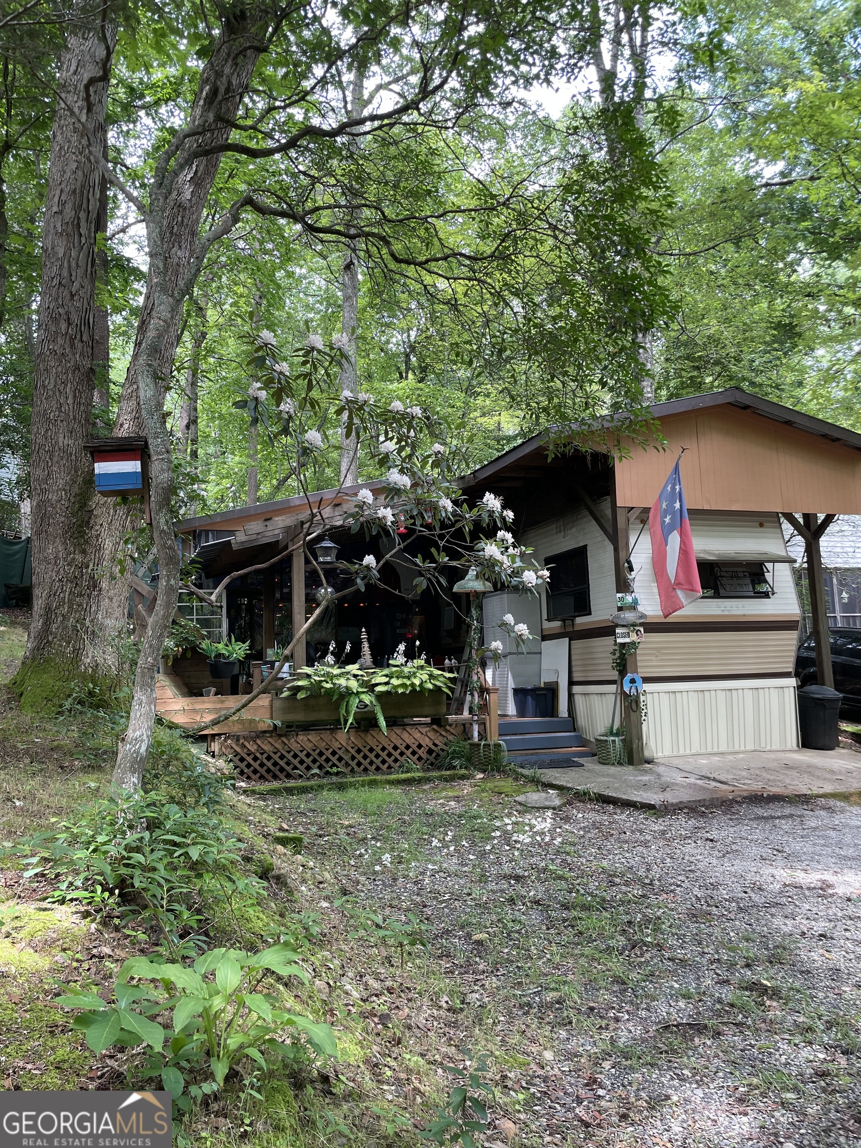 NEW LISTING IN MOUNTAIN LAKES - CLEVELAND, GA! Escape to the North Georgia mountains with this unique mountain retreat in the highly sought-after Mountain Lakes Resort, a private, gated community offering resort-style living year-round. Property Highlights: * 1 Bedroom, 1 Full Bath * Huge Covered Outdoor Area with Custom Bar * Beautiful Man-Made Waterfall Feature on Property Unmatched Community Amenities: * 24/7 Gated Security * Golf Cart-Friendly Roads * 50-Acre Lake Qualatchee - with Fishing, Kayaking, Swimming & a Scenic Waterfall * Clubhouse, Fitness Center, Sauna, and Steam Room * Pools, Waterslides, Mini-Golf, Playgrounds * On-site Chapel, Horseback Riding Trails * Weekly Community Events: Bingo, Movies, Game Nights & More Just minutes from Helen, local wineries, and scenic trails-this is more than a getaway, it's a lifestyle. Don't miss this rare opportunity in one of Cleveland's best-kept secrets - Mountain Lakes Resort!