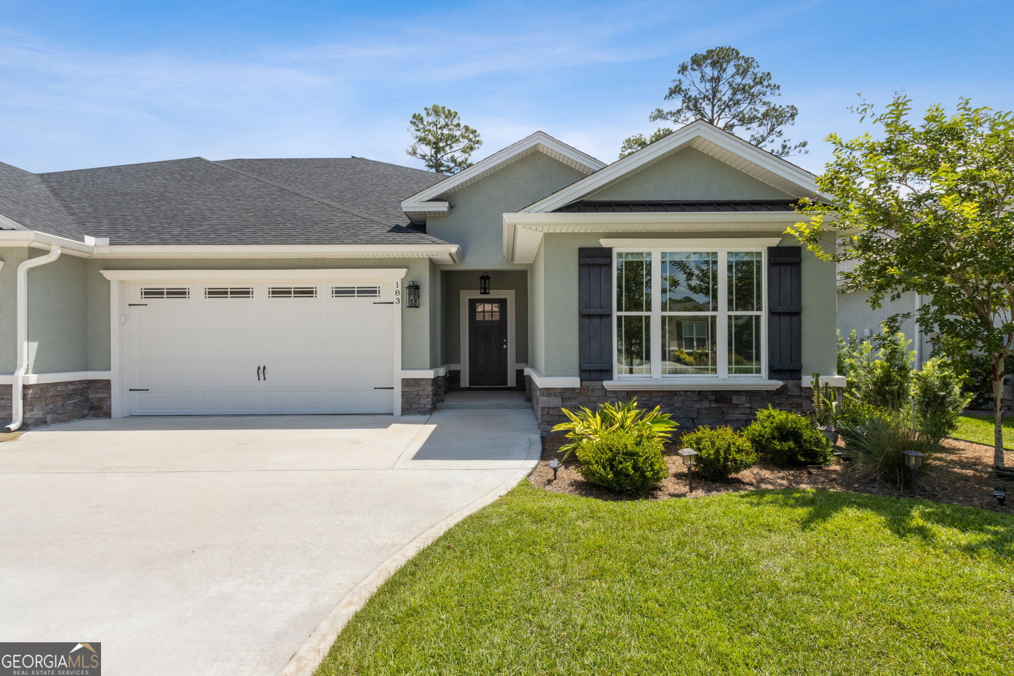 Welcome to 183 Ryan Nicholas Drive, located in the desirable Ryan's Cove neighborhood within the Laurel Island Plantation community. This beautifully maintained home offers 2,013 square feet of thoughtfully designed living space and shows like new. Featuring 3 bedrooms and 2 baths, the home boasts stylish tile flooring throughout the main living areas and a spacious, open-concept layout perfect for modern living. The gourmet kitchen is a true highlight, complete with solid maple stained cabinetry, stunning quartz countertops, under-cabinet lighting, upgraded fixtures, and a smart refrigerator with built-in TV. A reverse osmosis system (less than a year old) adds an extra touch of luxury and convenience. Retreat to the generous primary suite offering a large 10' x 10.5' dressing room with direct access to the laundry room, a spa-inspired bathroom with double vanities, a soaking tub, and a tiled walk-in shower. Open grid-less windows allow for an abundance of natural light throughout. The fully fenced backyard is enhanced by flowering trees that provide both beauty and shade, while a recently installed solar attic fan promotes energy efficiency. The oversized two-car garage includes T1-11 wood paneling and leads to an attic space with built-in shelving for abundant storage. Enjoy access to Laurel Island's community amenities, including a resort-style pool, fitness center, and the scenic Laurel Island Links golf course and clubhouse. Lawn maintenance and irrigation are included with the HOA, giving you more time to relax and enjoy your surroundings. Ideally located just minutes from I-95 and Kings Bay Naval Base, this home combines comfort, sophistication, and low-maintenance living in one of Camden County's most popular communities.