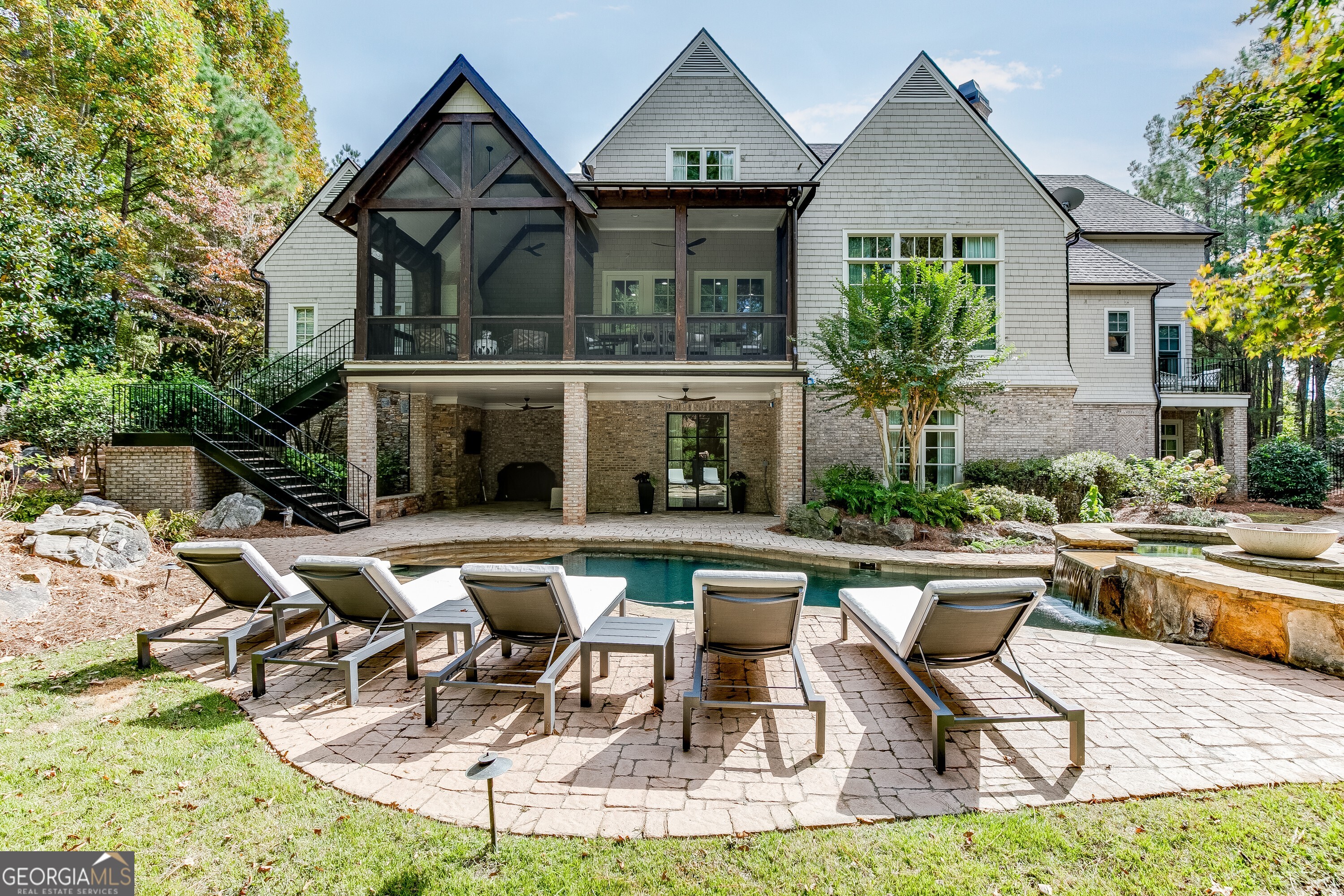 This 6-bedroom, 7.5-bath estate, fully renovated to perfection, is a true showcase of luxury and high-end finishes. Situated on a professionally landscaped lot, the property features a saltwater pool, double spa, and expansive outdoor living spaces offering unmatched craftsmanship and attention to detail. The main level opens with a grand entrance, featuring a circular driveway and double iron and glass doors. Inside, the main floor is highlighted by the owner's suite with a private balcony, a spa-like bath with Bianco Carrara marble, and a custom closet with marble countertops. The two-story living room, with a stone fireplace, flows into a gourmet kitchen outfitted with honed Carrara marble countertops top-tier appliances, and hidden pantry. Imagine cozy evenings by the gas fireplace on the screened-in porch or hosting intimate outdoor dinners in this serene setting. Additional exceptional features on the first floor include a custom wine cellar, Genesis elevator, dog shower, and a spacious, well-appointed laundry room. The second level boasts a second owner's suite with a versatile study/teen or in-law living area equipped with a microwave and ice maker. This floor also includes a junior owner's suite, two additional bedrooms with en-suite baths, and a secondary laundry room, ensuring effortless living for family or guests. Designed with entertainment in mind, the terrace level is a destination in itself, featuring a state-of-the-art home theater, billiards area, game room, and private spa. A third laundry room and a well-equipped kitchen ensure effortless hosting, while the en-suite bedroom with custom cedar double bunk beds adds charm and practicality for family or visiting guests. This Smart Home is equipped with cutting-edge technology, premium appliances, and designer fixtures, offering a level of refinement that surpasses even new construction homes. Located in The River Club, a haven of exclusivity, residents enjoy access to the Greg Norman premier private championship golf course, a Family Lakeside Sports Center, state-of-the-art Fitness Center, dining and spa services.