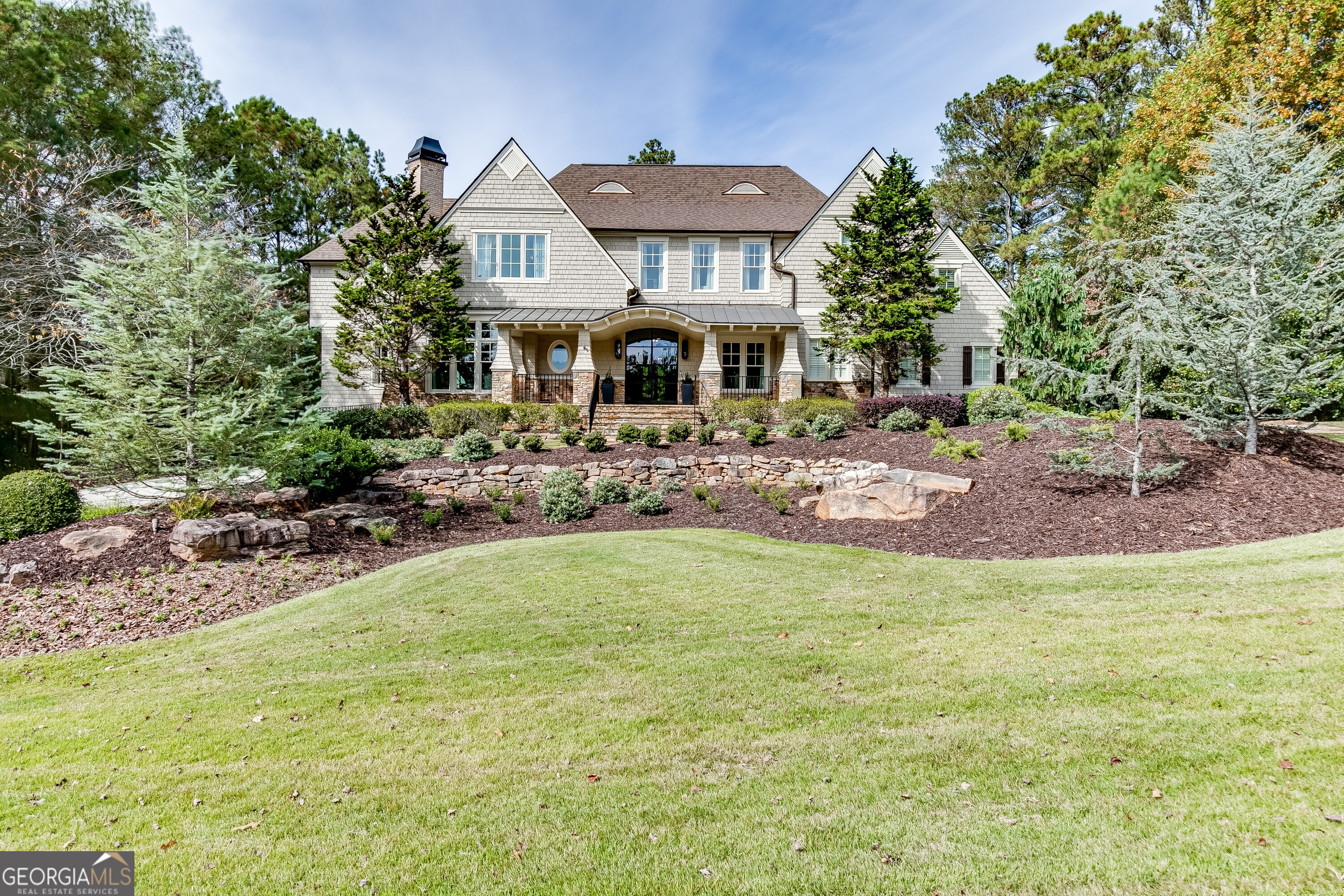 This 6-bedroom, 7.5-bath estate, fully renovated to perfection, is a true showcase of luxury and high-end finishes. Situated on a professionally landscaped lot, the property features a saltwater pool, double spa, and expansive outdoor living spaces offering unmatched craftsmanship and attention to detail. The main level opens with a grand entrance, featuring a circular driveway and double iron and glass doors. Inside, the main floor is highlighted by the owner's suite with a private balcony, a spa-like bath with Bianco Carrara marble, and a custom closet with marble countertops. The two-story living room, with a stone fireplace, flows into a gourmet kitchen outfitted with honed Carrara marble countertops top-tier appliances, and hidden pantry. Imagine cozy evenings by the gas fireplace on the screened-in porch or hosting intimate outdoor dinners in this serene setting. Additional exceptional features on the first floor include a custom wine cellar, Genesis elevator, dog shower, and a spacious, well-appointed laundry room. The second level boasts a second owner's suite with a versatile study/teen or in-law living area equipped with a microwave and ice maker. This floor also includes a junior owner's suite, two additional bedrooms with en-suite baths, and a secondary laundry room, ensuring effortless living for family or guests. Designed with entertainment in mind, the terrace level is a destination in itself, featuring a state-of-the-art home theater, billiards area, game room, and private spa. A third laundry room and a well-equipped kitchen ensure effortless hosting, while the en-suite bedroom with custom cedar double bunk beds adds charm and practicality for family or visiting guests. This Smart Home is equipped with cutting-edge technology, premium appliances, and designer fixtures, offering a level of refinement that surpasses even new construction homes. Located in The River Club, a haven of exclusivity, residents enjoy access to the Greg Norman premier private championship golf course, a Family Lakeside Sports Center, state-of-the-art Fitness Center, dining and spa services.