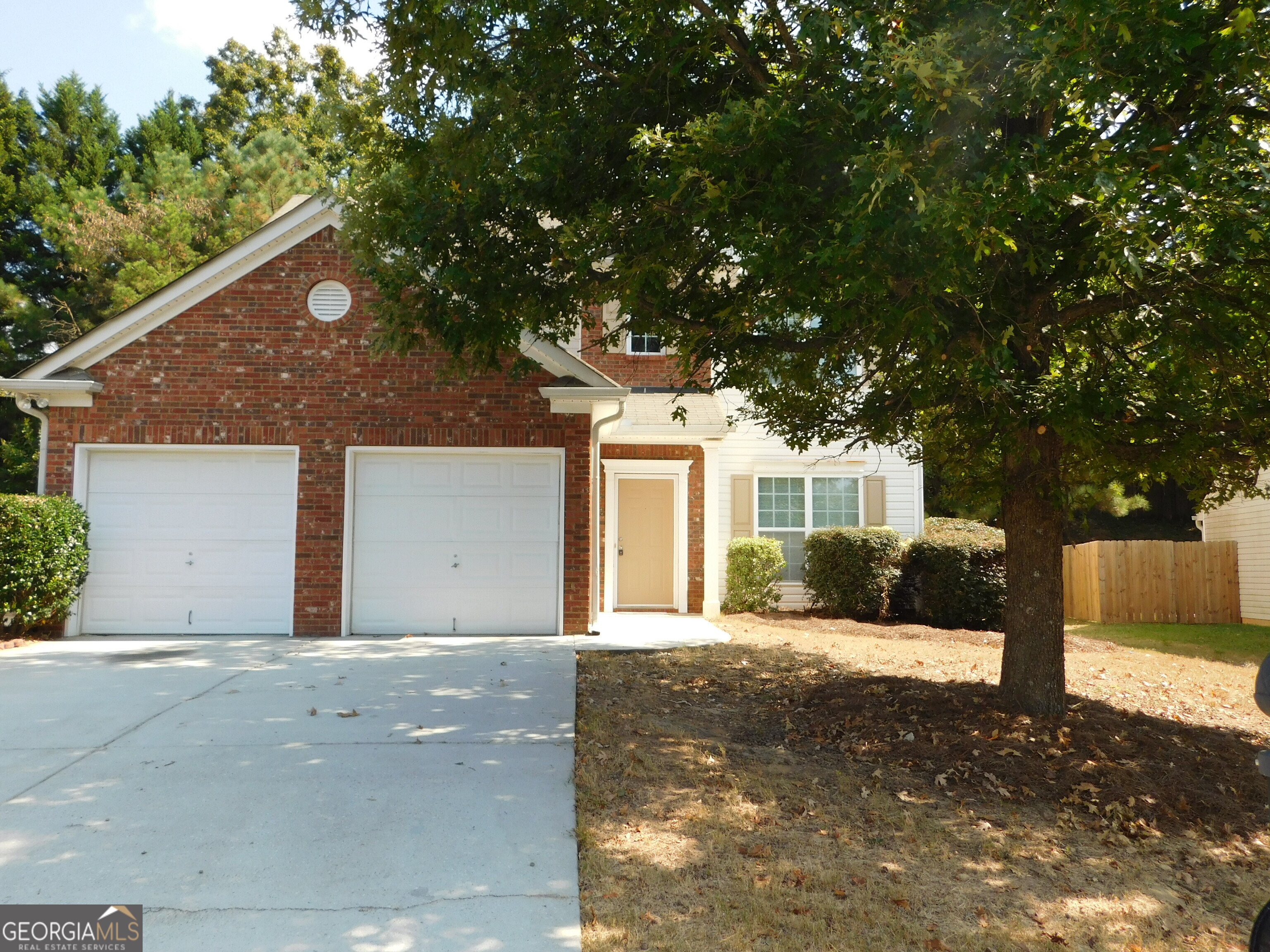 Two-story four bedroom home. The main floor has an entry foyer, living & dining room, spacious family room with gas fireplace, bright kitchen with range hood, stove, dishwasher, refrigerator with access to a back patio, and half bath. Hall access to the 2-car front entry garage. Upper level features laundry room with washer/dryer hook-ups, three spare bedrooms (including a large room over the garage) and a full hall bath with tub/shower combination. Vaulted master bedroom with attached master bath with garden tub, stall shower and walk-in closet. Located off of Stone Mountain Hwy, walking distance to shopping plazas, grocery stores, gas stations, Lowe's, Wal-Mart and minutes to Stone Mountain Memorial Park and schools. Property is investor owned and being sold 'as-is' with no Seller's Disclosure.