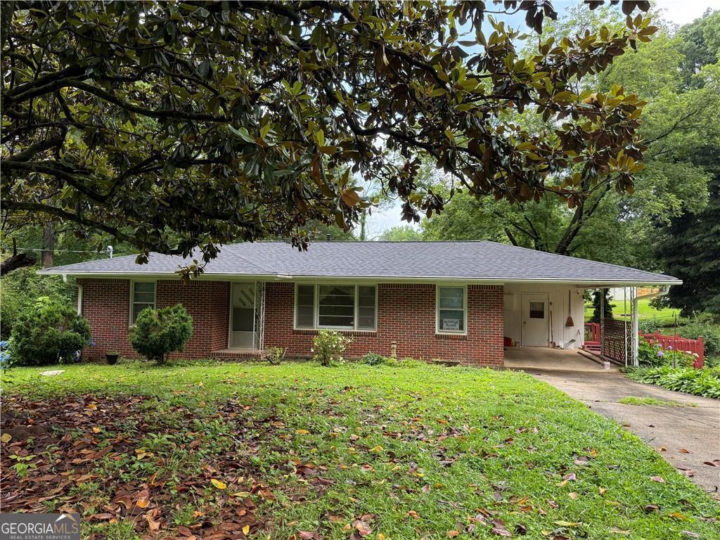 This charming 2-bedroom, 1 and a half bath home sits on a level quarter-acre lot in a quiet, well-kept neighborhood. Built in 1959, it features newly refinished hardwood floors and fresh pain throughout. Relax in the enclosed sunroom with a wood-burning stove-perfect for enjoying the space year-round. The home also has two outbuildings with electricity, great for a workshop, storage, or hobbies. New breaker box. Roof and A/C are less than 5 years old. Refrigerator, washer/dryer included. New stairs off sunroom. Located near Cobb Hospital, the East-West Connector, and the Silver Comet Trail, this home offers comfort, character, and convenience. Don't miss out!