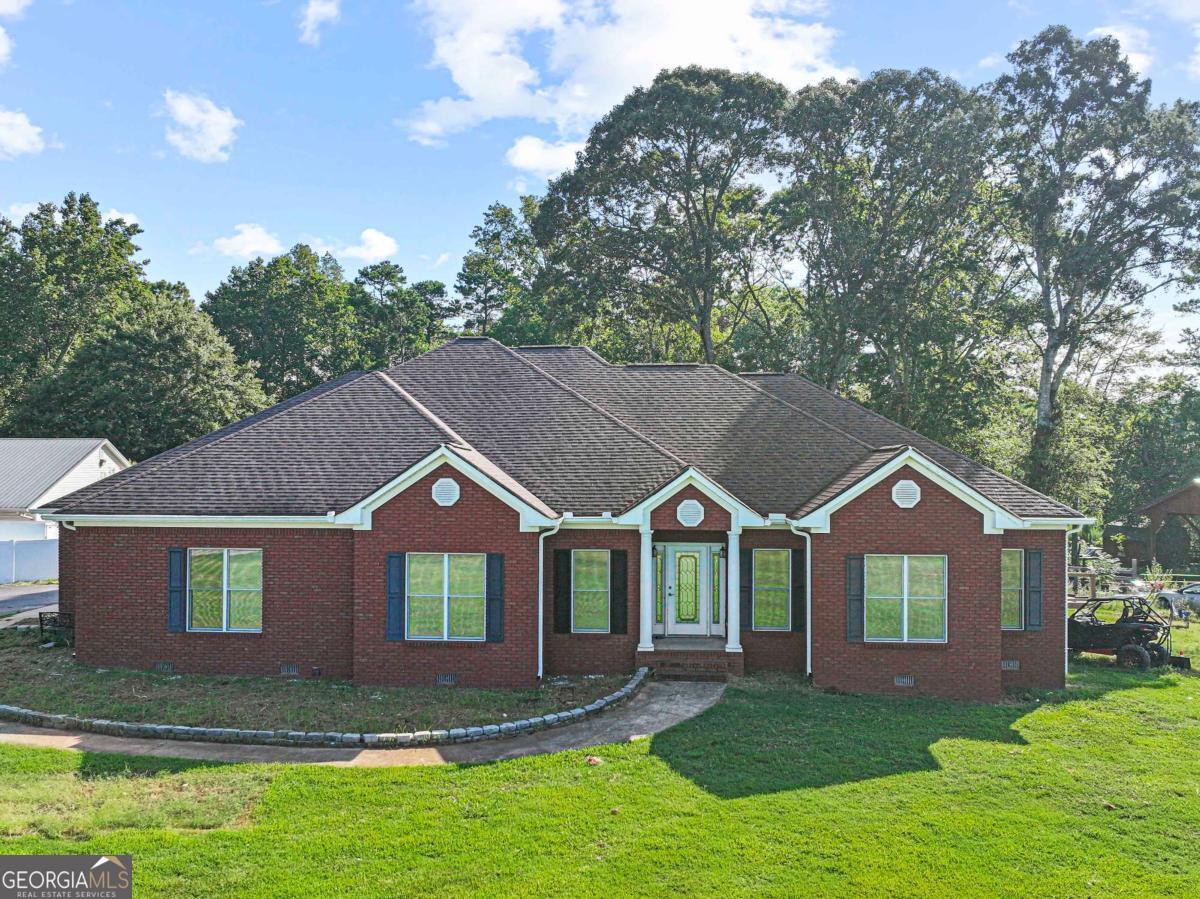 **Charming 3-Bedroom, 2-Bath Brick Home on 3.27 Acres** **2,326 Sq. Ft. 2 Barns RV Hookup Wheelchair Accessible** Experience peaceful country living with modern updates in this beautifully maintained 3-bedroom, 2-bathroom brick home situated on a spacious 3.27-acre lot. With 2,326 square feet of living space, this home combines comfort, convenience, and style, all while being fully wheelchair accessible. Inside, the open layout features a newly updated kitchen equipped with granite countertops, stainless steel appliances, and a wine cooler (Stays with the property). The master suite serves as a private retreat, complete with a walk-in closet, a soaking tub, a separate shower, and a double vanity. For added comfort, new ceiling fans with remote controls have been installed in both the living room and the master bedroom. Additional highlights include: - A new HVAC system (installed in 2023) - A new back deck ideal for outdoor entertaining - A fenced-in backyard, perfect for children or pets - Two barns offering ample storage and workspace - An RV hookup for convenience and travel flexibility Whether you're seeking serene living with room to grow or a move-in-ready home with modern finishes, this property meets all your needs.