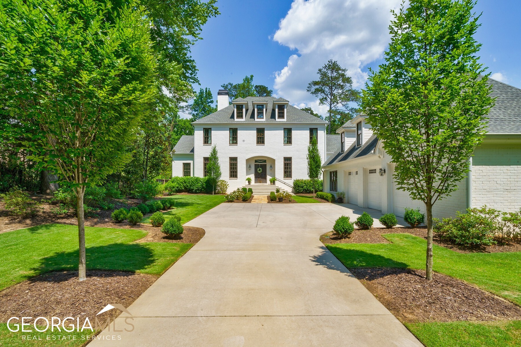 Introducing a truly majestic residence nestled within a gated lot adorned with mature trees and a fenced yard-the epitome of elegance and privacy. Boasting stunning curb appeal, it is located in Historic Brookhaven, Georgia's earliest planned golf club community, the first example of suburban development with a golf course serving as its central focus. Experience a harmonious blend of comfort and seamless indoor-outdoor living with a main-level primary suite (boasting a luxurious wet room) and a breathtaking inground pool area that provides a picturesque setting for summer tranquility. Prepare to be captivated by the sheer size and space. A grand front entrance precedes an impressive layout encompassing six generously proportioned bedrooms, five full bathrooms and one half bathroom spanning 6,100+/- square feet. Natural light accentuates the gleaming hardwood floors throughout and floods an interior featuring soaring 12-foot ceilings on the main level. Nestled to the right of the two-story foyer, a banquet-sized dining room awaits, graced with sophisticated crown molding and ample space for hosting 12+. Connecting flawlessly to the open-concept chef's kitchen through an elegant butler's pantry, this layout is an entertainer's dream. A true masterpiece, the chef's kitchen boasts high-end stainless steel appliances, a generously sized marble island with seating, opulent Calcutta Vagli marble countertops, plentiful cabinet storage, a convenient walk-in pantry and unobstructed sightlines to both the inviting family room and the cozy fireside great room. Just off the foyer, a bonus room with floor-to-ceiling built-ins beckons, offering endless possibilities as a well-appointed office or study. Bathed in natural light, this space provides an inspiring and comfortable environment for work or study. Experience ultimate serenity in the main-level primary suite, a tranquil haven offering captivating views of the poolside backyard. Relax in the bedroom's inviting sitting area and enjoy the convenience of walk-in his and her closets. The spa-inspired en suite bathroom features vaulted ceilings, dual vanities, a lavish soaking tub and a wet room shower with built-in seating. Beyond the great room, French doors open up to the captivating covered veranda, enhanced by the cozy warmth of a fireplace and the timeless charm of shiplap siding. Whether it's a peaceful morning coffee or an informal dinner gathering, this inviting outdoor space creates an idyllic backdrop for moments of connection. Follow the graceful descent of the stairs to discover a captivating patio and expansive backyard, where a stunning inground pool area awaits. Perfectly designed for the ultimate summer retreat, it offers seamless outside access to the daylight basement on the terrace level. Unveil a world of possibilities on the second level, where a collection of four additional bedrooms and three additional bathrooms expertly blend functionality and luxury, ensuring that everyone has their own private space. Additionally, above the three-car garage, a versatile bonus room awaits. With its ample space and convenient location, this room transforms into an inviting guest suite. Perfectly positioned within the highly sought-after Ashford Park Elementary School district, 2799 Mabry offers unparalleled access to the wealth of shopping, dining and recreational options that Brookhaven has to offer. With its sought-after location and exceptional features, this is an opportunity not to be missed to own a truly remarkable piece of Brookhaven's rich history.