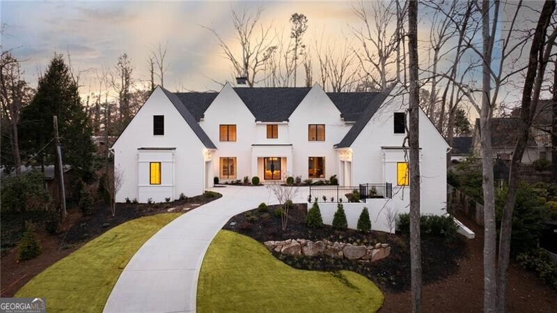 Introducing a masterpiece of modern luxury living in the prestigious Buckhead/Sandy Springs area. Designed by Harrison Design and meticulously crafted by Sheehan Built Homes, this stunning new construction is a testament to elegance and sophistication. Step inside to discover an open concept living space that exudes opulence at every turn. The main level boasts a seamless flow from the grand foyer to the expansive living area, leading to a covered fireside porch overlooking the sparkling pool-a true outdoor oasis. The gourmet kitchen is a chef's dream, featuring state-of-the-art appliances, a massive island, and a scullery for all your culinary needs. Entertain with ease in the spacious dining area or unwind in the cozy family room, both offering breathtaking views of the surrounding landscape. The primary suite is a private sanctuary, complete with dual walk-in closets and a luxurious spa-like bathroom. Additional features on the main level include ample office space and a magnificent wet bar, perfect for hosting guests in style. Upstairs, you'll find four generously sized ensuite bedrooms, each offering unparalleled comfort and privacy. A second laundry room adds convenience to this luxurious abode. The terrace level is an entertainer's paradise, featuring a sprawling rec room, exercise room, future wine room, bedroom, and full bath. Storage is abundant, ensuring there's plenty of space for all your belongings. Situated on a private hilltop setting, this home offers tranquility and seclusion, yet is just moments away from the finest schools, highways, and amenities that Buckhead and Sandy Springs have to offer. Don't miss this rare opportunity to own a true masterpiece of luxury living. See this home and experience the epitome of refined living in Atlanta. Welcome Home!