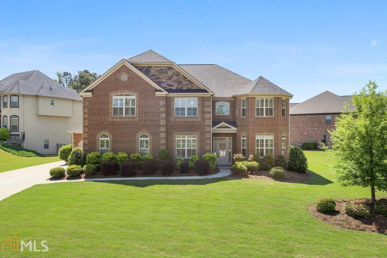This magnificent 4 sided brick, open concept home with an oversized Master on Main atop a hill awaits your immediate move-in. Why wait months for new construction? This home boasts five bedrooms and three and a half bath. Featuring new plantation shutters throughout, granite counters in kitchen and master bath, and laundry rooms on both levels. Relaxing evenings await you on the back porch complete with ceiling fans. All 5 bedrooms are generously sized complete with massive walk- in closets.Prepare large meals with ease thanks to a gas cook top and double ovens. Catch a glimpse of Lake Erma from the upper front 2 bedrooms just across the street. The second floor bedrooms feature Jack and Jill baths with each bedroom having a private sink area and linen closet. The upper level also boasts a large loft area ready for a myriad of uses. Never struggle with laundry as both levels have dedicated laundry areas. Welcome guests or family with room to spare from large bedrooms to multiple dining areas. Your new home will dazzle at night as well when the sun goes down the elegant landscape and architectural lighting will take center stage. Storage should not be and issue with ample pantry space and multiple storage inside. Additional storage and or living space awaits the creative homeowner in an area just of the main garage. Let you furry friends roam in a yard complete with a dog watch electric fence. A 3rd car garage and long driveway compliments this stunning home. Live peacefully on one of the quietest streets in the neighborhood. Excellent community features included gated entry, golf, a lake, pool and tennis courts, Don't forget the country club!