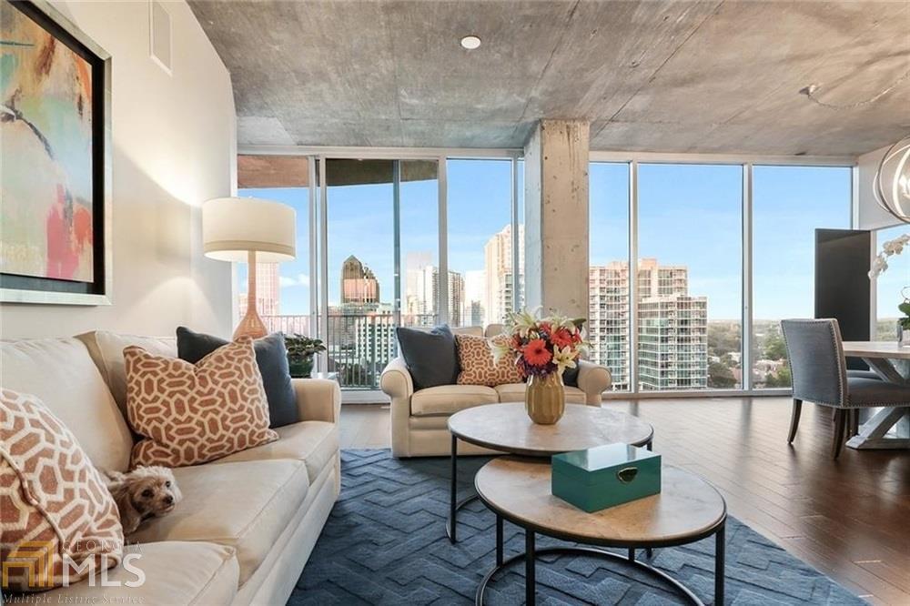 Live in your very own glass box above Peachtree street in the heart of midtown. This Stunning combination of two spacious homes has resulted in this oversized 3 bedroom 3 bath oasis. Unparalleled skyline views from the immense living space and the bedrooms. Custom designer kitchen offers professional stainless appliance package, island w/ waterfall countertops & custom backsplash. Custom designer Master bathroom. Two walk-out balconies. This home comes with 3 prime parking spaces. Walk to everything Midtown has to offer including Marta, Shopping and much more!