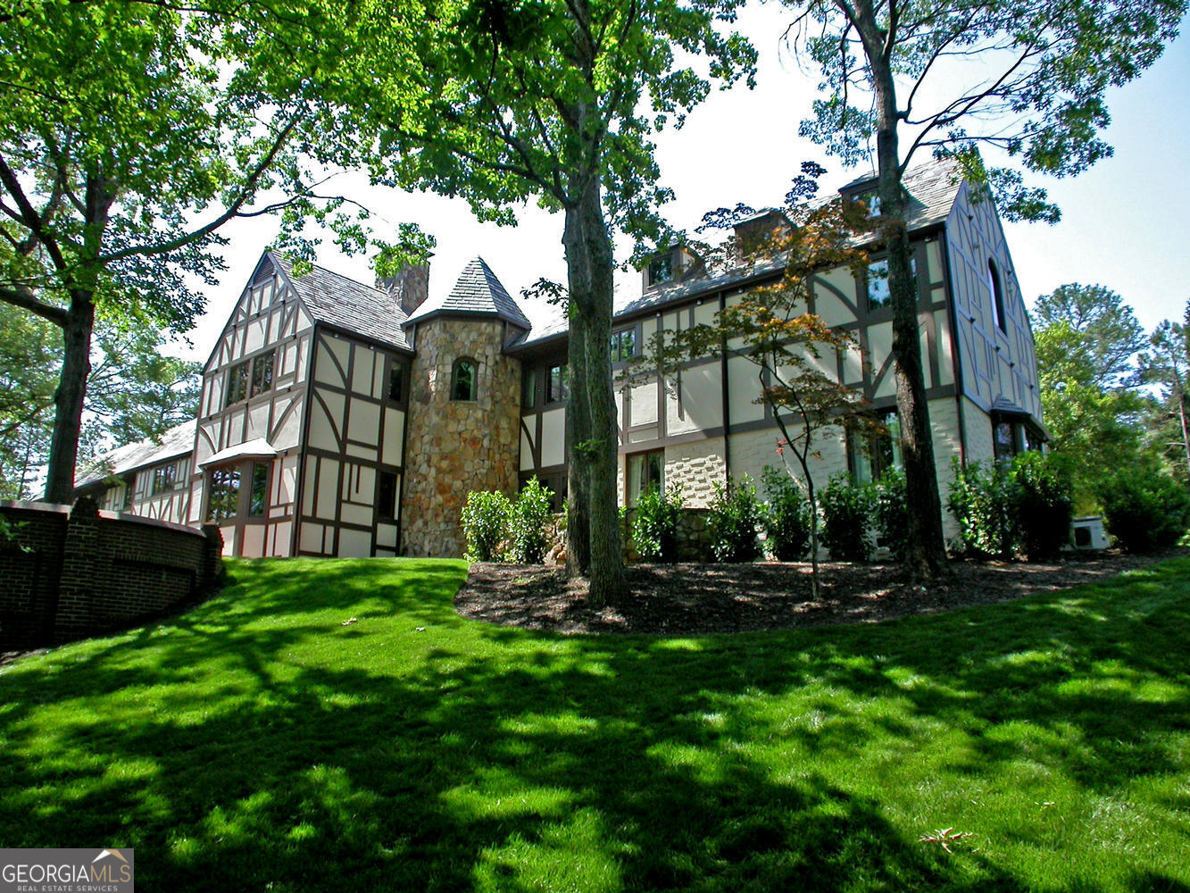 Gated Lions Gate Estate on 3.16 manicured private park like acres fully fenced in Sandy Springs. Total privacy w walk out main level gunite heated salt water double Pool w bridge, Jacuzzi, Waterfall, Fireplace, Outdoor Grill w double Frig, covered Bath House w Full Bath for pool/hot tub. 4 car garage w large courtyard for additional parking and/or entertaining. Solid well built stone, brick, hard coat stucco home w beautiful multi colored slate roof. Circular driveway, 2 story Foyer, front and rear staircases, 4 stone Fireplaces. Large kitchen overlooking Pool w double Sub Zero refrigerators. Home and property have been meticulously maintained. Owner Financing available with 50% down at 5% with interest only payments for 36 months. No Mortgage Lender can do that!