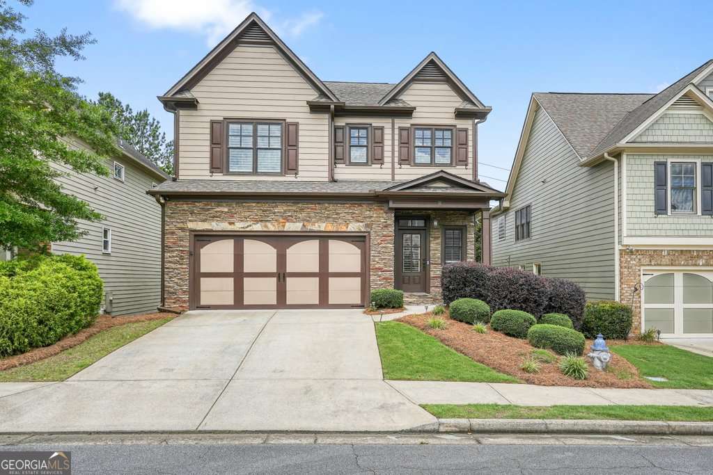 Welcome to this stunning home in Cornerstone Park filled with thoughtful upgrades and so much character. Hardwood floors flow throughout the main level, where you'll find a spacious kitchen with an oversized island perfect for entertaining. A large walk-in pantry with custom shelving will make the at-home chef happy along with stainless steel appliances, beautiful cabinetry with undermount lighting, and lots of countertop working space. The kitchen, family room, and open dining area are truly the heart of the home and combined work so well for gatherings. Step out onto the covered porch room for relaxing evenings outside and grill on the separate uncovered deck on the kitchen level. A cozy stone fireplace framed by custom built-in bookcases and storage cabinets adds so much detail not always found in new construction today. Upstairs, retreat to your oversized owner's suite complete with a luxurious bath, separate tub and shower, and TWO custom walk-in owners closets. Every closet in the home has been outfitted with custom sensor lighting and built-ins for ultimate organization. Large secondary guest bedrooms with guest bath in the hall and a light and bright laundry room with custom built-ins complete the upper level. The fully finished basement offers a large media/rec room, a sleek wet bar with copper hammered sink, and a full bath-ideal for hosting guests or game nights. Retreat to the private fenced backyard oasis with over $15K in outdoor ambient lighting, beautiful landscaping, shaded patio under the deck and custom stairs to connect upper and lower levels of outdoor living space. NEW (2024) Navian Tankless hot water heater, NEW A/C systems (2021 and 2024) storage room, NEW garage door updates and camera system (2024). Maintenance is easy and includes front and back yard maintenance included in the HOA and you'll have peace of mind with the programmable Rainbird Irrigation system with front and rear zones. Located in a sought-after community with top-rated schools, conveniently located off of Hwy 92 and 15 min to Downtown Roswell, 25 min to Avalon and DT Alpharetta. This one won't last long!