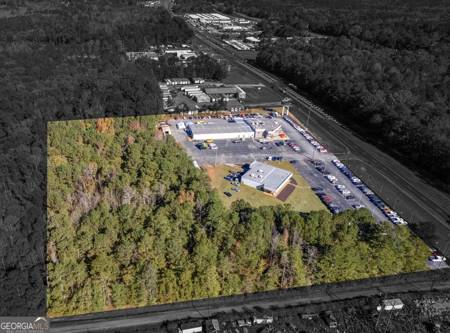 REDUCED PRICE ON THIS PRIME 8.43 Acres AND STATE OF THE ART BUILDINGS. Does not include Motor Max Car Dealership Business. Zoned C4. Approximately 616' road frontage. The main office building and service center has approximately 13556 sq ft. Also includes adjacent showroom building with 2500 sq ft. Main building features  8 glass offices, 2 private offices, 4 restrooms, mechanic shop with 8 lifts and 9 car spaces, 3 roll up doors and 1 small bay door and parts room. Plus 22 x 27 detail paint bay shop, Upstairs area features kitchen, board room, 3 offices and lots of storage. The separate 2500 sq ft building features a showroom, kitchen and 2 offices with large covered porch area. Many usage of this building. Lots of road frontage on Hwy 19/41 with 2 gated entrances, approx 35 light post with approx 4 acres paved parking lot and  approx 200 parking spaces. 3-phase, 600 amp ideal for accommodating heavy machinery and equipment. Great property for development or car dealership. Great location with close proximity to Atl, I-75,PTC and surrounding areas. Many options for this property.   This property can be divided into 2 parcels. Small showcase building includes 3 to 4 acres (to be surveyed by the Seller). Great for restaurant, offices, paint body shop etc. To be approval by Planning & Zoning. Priced at $2,500,000     Main building as described above with approx 4+ acres (to be surveyed by Seller). Priced at $3,500,000. Call for more information.