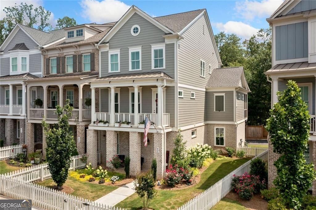 Enhance your lifestyle in this beautiful three-story end-unit townhouse featuring an ELEVATOR by John Wieland at South on Main! A perfect blend of modern design, luxury finishes, and unbeatable amenities awaits. Step inside this luxurious plan designed for contemporary living. The expansive three-car garage with EV charging opens into a mudroom with bench seating, cubbies, and hooks for effortless organization. A keeping room with extra windows bathes the space in natural light. At the same time, the gourmet kitchen boasts 10-foot ceilings, tall cabinetry, quartz countertops, stainless steel appliances (including a microwave drawer) and a walk-in pantry. The kitchen flows seamlessly into the great room, featuring a gas log fireplace and built-in bookcases. Retreat to the primary suite with its private relaxation nook and an ensuite bath complete with a soaking tub, frameless glass shower, and tile to the ceiling. Upstairs, retreat to the primary suite with its private relaxation nook and an ensuite bath complete with a soaking tub, frameless glass shower, and tile to the ceiling. You will also find a secondary bath, and a laundry room with an extra-deep sink. Outdoor living shines with two front porches and a screened rear deck with Trex decking perfect for grilling. Upgrades include outdoor landscape lighting, landscaping, and plantation shutters. Located less than half a mile from downtown Woodstock, South on Main offers premium amenities, including a 6,000 sq. ft. clubhouse, fitness center, pool, dog parks, community garden, and more. Direct access to the Noonday Creek Trail makes this a dream home for active lifestyles!
