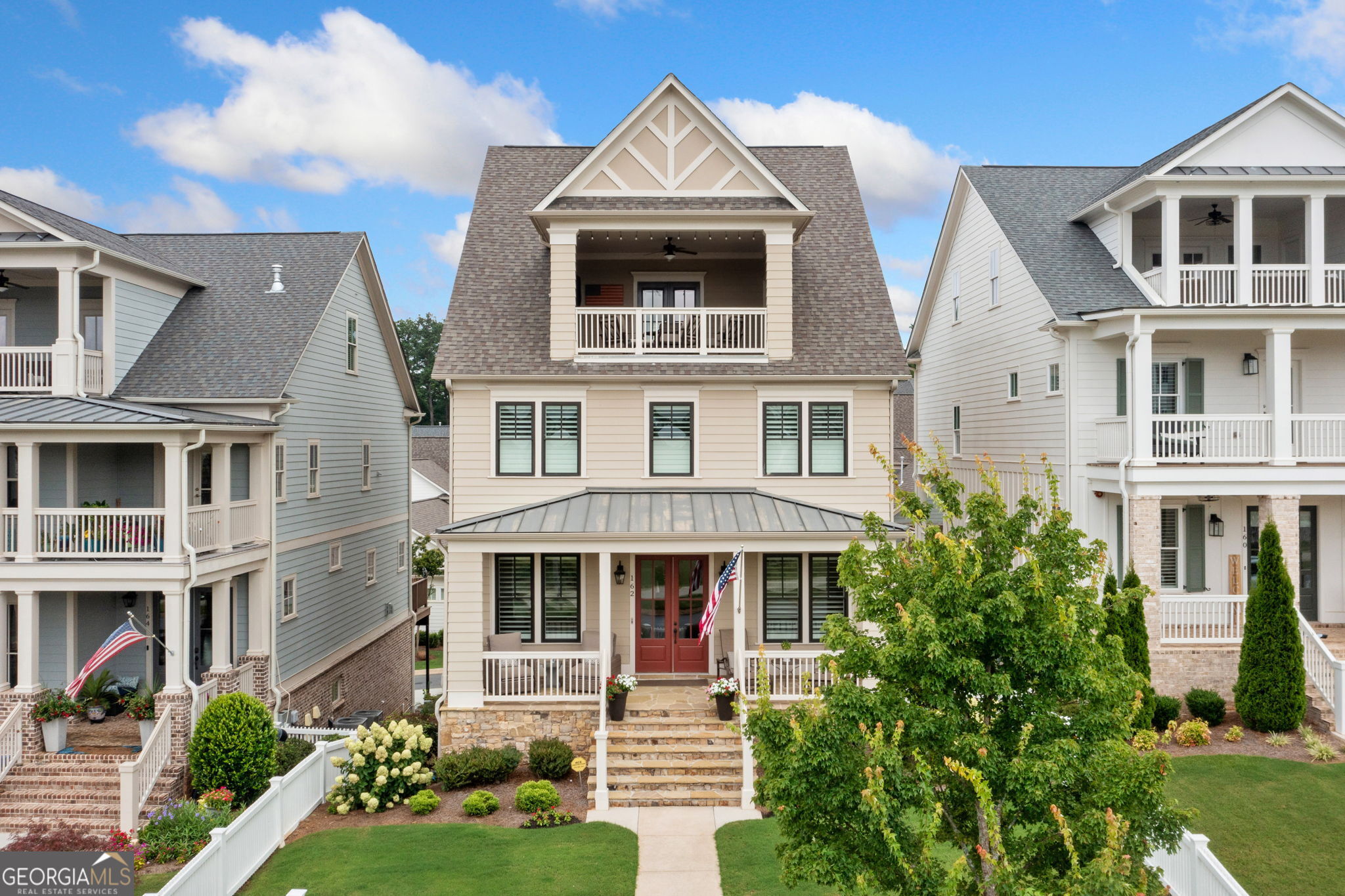 Experience the lifestyle you have dreamed about in South On Main - Downtown Woodstock's Premier Community. Welcome to an exceptional opportunity to live in the heart of Downtown Woodstock's most sought-after neighborhood-South On Main. Nestled on a premier lot, this beautifully crafted four-story luxury home offers refined living at every level, complete with 5 bedrooms, 4.5 baths, a private elevator, and designer upgrades throughout. Step inside and discover a home bathed in natural light, where expansive windows, plantation shutters and an ideal orientation make every room feel bright and inviting. The main level is thoughtfully designed for both gracious entertaining and comfortable everyday living, featuring a formal dining room with upgraded trim, a welcoming sitting/office room with custom French doors, and an open-concept living space with upgraded lighting and custom finishes. The beautiful family room features built-ins on either side of the fireplace. At the heart of it all lies the chef's kitchen-a true culinary masterpiece. Outfitted with custom cabinetry, quartz countertops, a Thermador dual-fuel convection oven, and a generous center island, this space is sure to inspire your inner gourmet. Step outside to enjoy dining on the deck or unwind with a drink on the covered porch-perfect for morning coffee or sunset cocktails. Upstairs, the primary suite is a private sanctuary, showcasing elegant wainscoting, a spa-inspired ensuite bath with a soaking tub, double vanity, and an oversized walk-in, custom closet. Two additional bedrooms share a stylish Jack & Jill bathroom, and the spacious laundry room with a barn door-complete with a sink-adds everyday ease. The top-level is your personal retreat in the sky, featuring a fourth bedroom, full bath, and a generous bonus living area that opens to a Sky Terrace with panoramic views of the community garden and surrounding neighborhood. The terrace level brings even more versatility with a home office or media room, plus a flex space perfect for a guest suite, 5th bedroom or workout space with its own full bath. Completing this luxurious home is a 3-car garage, mudroom, irrigation system, and fully fenced yard! And perhaps best of all? You're just a short stroll or golf cart ride away from Downtown Woodstock's award-winning restaurants, boutiques, breweries, parks, and community events. This is more than a home-it's a lifestyle. Don't miss your chance to own one of the most feature-rich properties in South On Main.