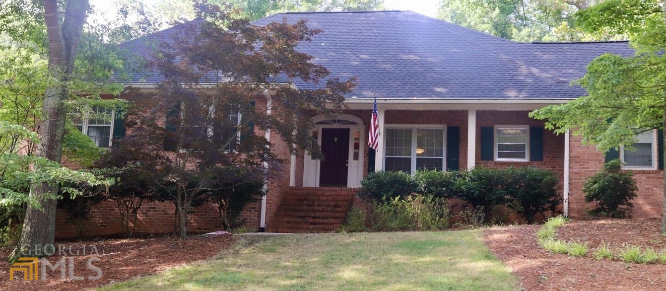 What a wonderful home, inside and out. Watch the world go by from your front porch - plenty of room for a swing or rockers. From the hardwood-floor entry hall to the right you'll find a large eat-in kitchen. All appliances are included. There's a pantry, a desk area, custom cabinets, window over the sink - everything a foodie could love. And direct access to the garage and storage. There's a formal dining room. And a casual living room with 2 sided-fireplace, wet bar and bookshelves. Behind that is the 'heart of the house' - a giant space with vaulted ceilings & skylights - perfect for big craft projects, a billiards table or ........ There are 3 spacious bedrooms - all with private baths - plus an office. How about a screened porch for watching the birds? New roof in 2019. Optional HOA maintains the entry, park, pool and tennis/pickleball courts. Super value in sought-after Woodhaven