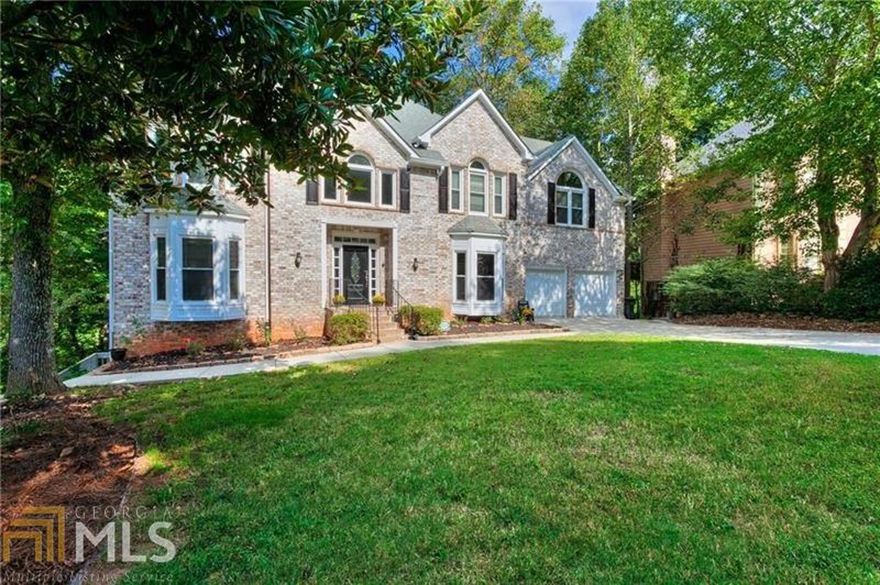 TWO HOMES FOR THE PRICE OF ONE! This home is a must see! This six (possible seven) bedroom house is located in one of the most sought after school districts in Georgia. Largest house in the subdivision, with an in-law suite that has a full kitchen. Natural hardwood floors throughout and custom counter tops. No need to preview! This home will not last long!