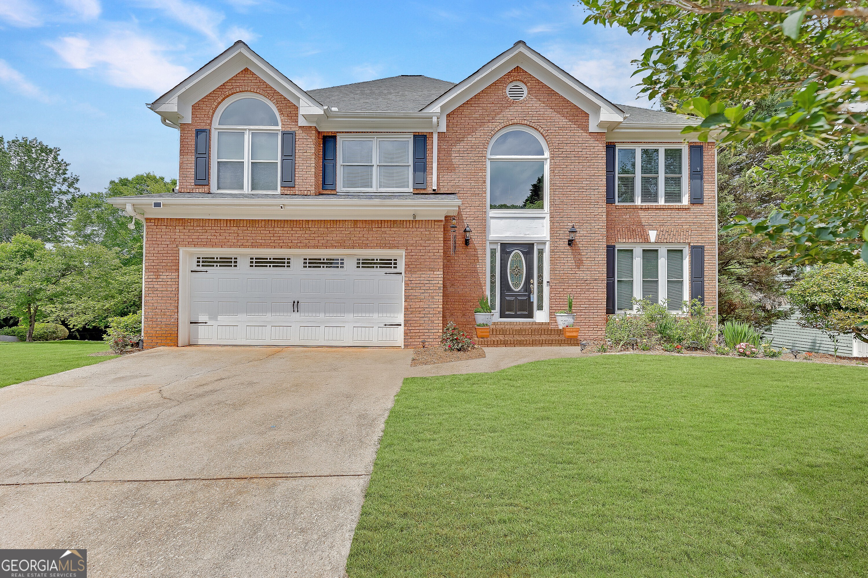 Welcome to this beautifully updated 4-bedroom, 2.5-bath home near Lake Lanier, top-rated schools, and downtown Flowery Branch. With a large flat yard, unfinished basement, and key home maintenance updates already completed, this property is ideal for a growing family looking for space, comfort, and peace of mind. Inside, you'll find a bright two-story foyer, formal living and dining rooms, and an updated kitchen with stainless steel appliances, granite countertops, and white cabinetry that opens to a light-filled family room with walls of windows. Upstairs, the oversized primary suite offers a granite double vanity, soaking tub, frameless walk-in shower, and spacious walk-in closet. Three additional large bedrooms (or optional playroom) and a generous upstairs laundry room provide everyday convenience. The unfinished basement is ready for future expansion perfect for a playroom, media room, workshop, or additional living space. Outside, enjoy a newly-built deck with stairs overlooking a flat, fenced backyard plus a flat side yard, creating ample space for kids, pets, and outdoor entertaining. Important Updates: newer HVAC, new hot water heater, replaced windows, fresh paint throughout, and new deck.