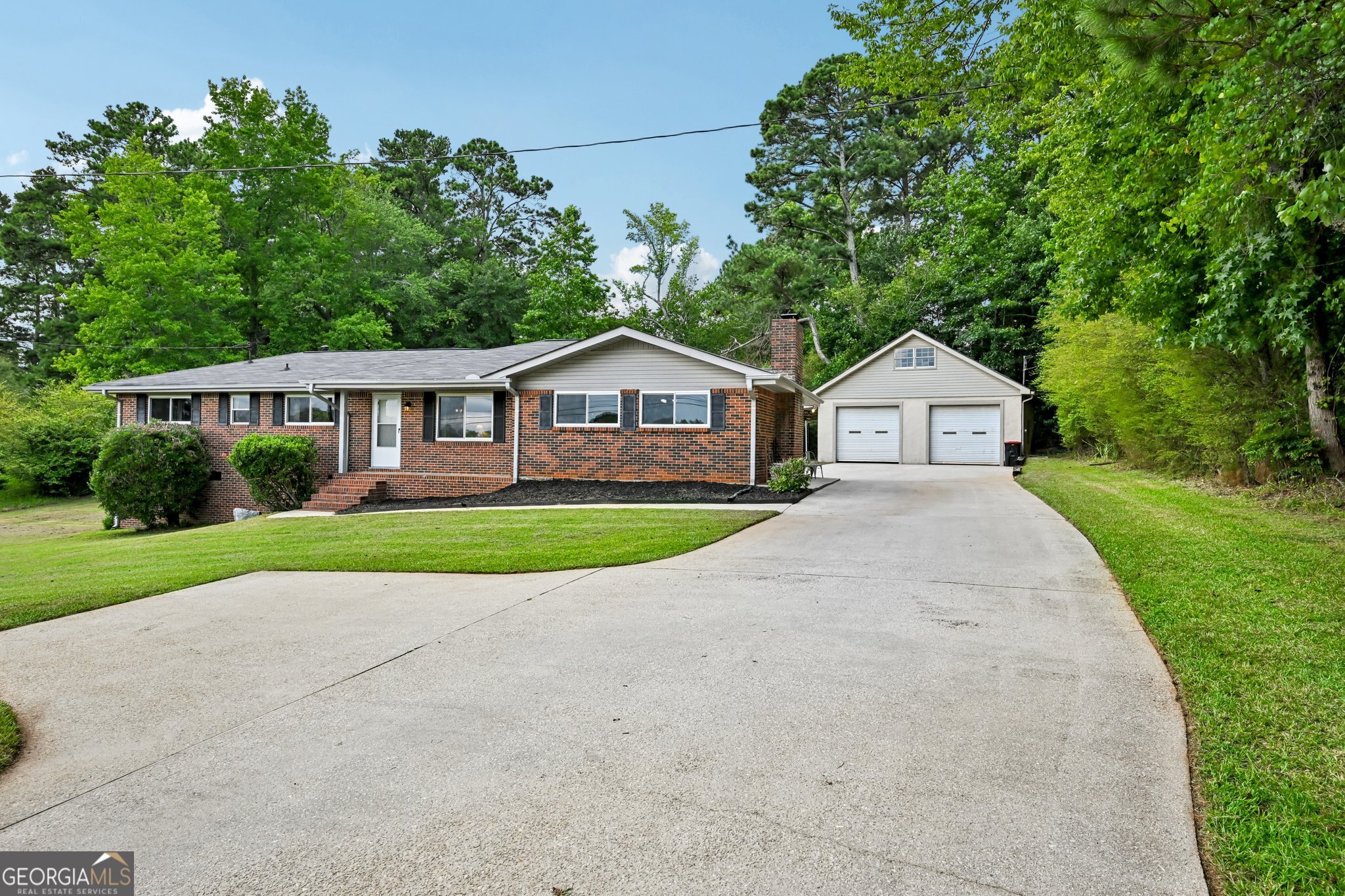 Bundled service pricing available for buyers! Connect with the listing agent for details. Welcome home to this fully updated 4-sided brick, 3-bedroom, ranch situated on a generous, private lot in Douglasville. Move-in ready with major updates already done, this home offers a perfect blend of modern upgrades and classic charm. Step inside to discover new flooring throughout, fresh exterior doors, updated bathrooms, and brand-new energy-efficient windows that flood the space with natural light. The formal living room welcomes you in and flows effortlessly into a cozy fireside family room-ideal for relaxing evenings or entertaining guests. The beautifully remodeled kitchen features granite countertops, sleek white cabinets, and stainless steel appliances. Enjoy peace of mind with a new roof, new HVAC system, and new hot water heater, ensuring years of low-maintenance living. Outside, a spacious deck overlooks the expansive backyard-perfect for summer gatherings or quiet mornings. The detached 2-car garage is more than just parking-it's equipped with electricity, a half bath, and an unfinished upstairs loft, making it a flexible space ideal for a workshop, gym, man-cave, game room, or even a future rental/ADU conversion. In addition to generous storage and workspace, the shop is fully equipped with a 220-volt electrical line, ideal for powering heavy-duty tools, welders, or EV chargers. A dedicated water spout in the garage offers convenient access for car washing, detailing, and routine maintenance-a rare and valuable feature for auto enthusiasts or hobbyists. Additional highlights include no HOA, tons of parking, and quick access to I-20, shopping, and schools. This move-in ready home offers the comfort, flexibility, and convenience you've been searching for. Don't miss out-schedule your showing today!