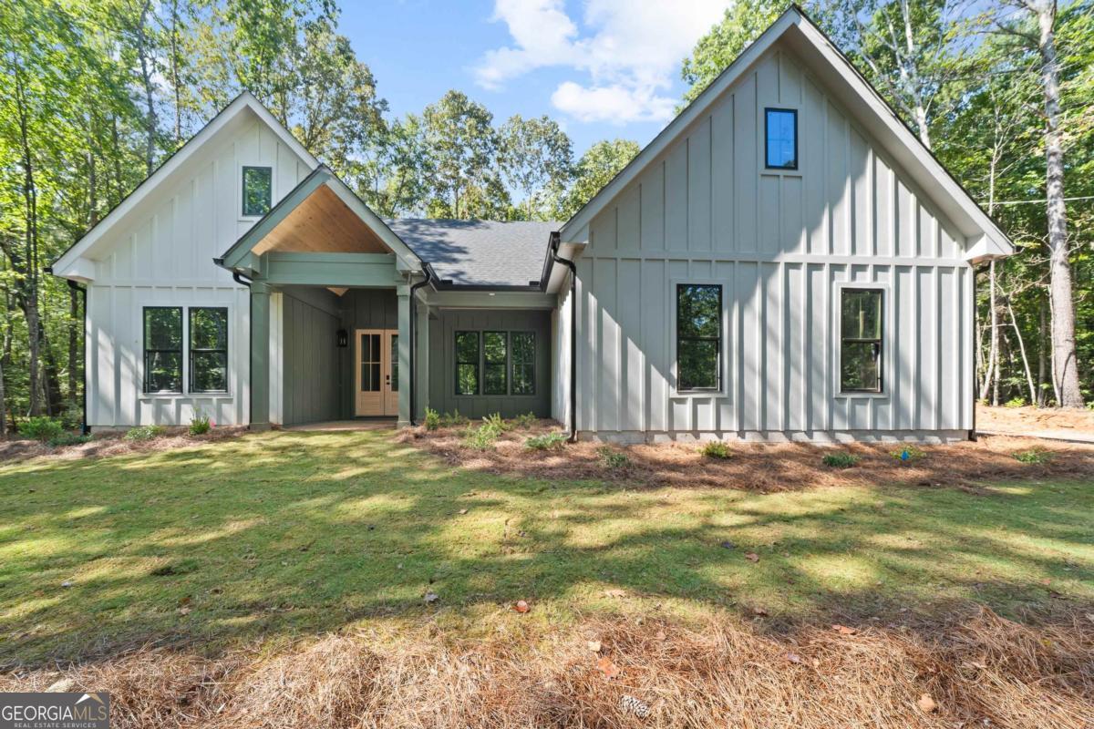 STUNNING New Construction on NEARLY 3 acres!! This home has BEAUTIFUL finishes that feature 10-foot ceilings, 8-foot interior doors, spray foam insulation, vaulted ceilings, floor to ceiling stone fireplace (gas logs), high-end Forno Appliances, Quartz Countertops, Custom Tile Shower in the master with tile floors, Vaulted Ceiling in Master Bedroom, Walk-in Closet with custom shelving, beautiful vanities, custom cabinetry and SO MUCH MORE! This home is so private, situated on 2.85 acres, this home sits way off the road and you have a plenty of privacy from neighbors - you don't have to see them unless you want to! This home has a beautiful open concept that is perfect for entertaining - the kitchen is drop dead gorgeous with custom light fixtures, custom backsplash, beautiful appliances, custom cabinets and gas range. Two guest bedrooms are situated on one side of the home that share a bathroom in the hall. On the other side, you have your master suite, laundry room, pantry and garage access. Kitchen, living room and porch access are all in the middle. Sliding glass doors give you access to the back porch that has wood ceilings and tons of privacy overlooking the backyard. The backyard has room to add a pool in the future! This home has it all - all the upgrades and custom features you want! Make it yours today!!! Agent/Owner