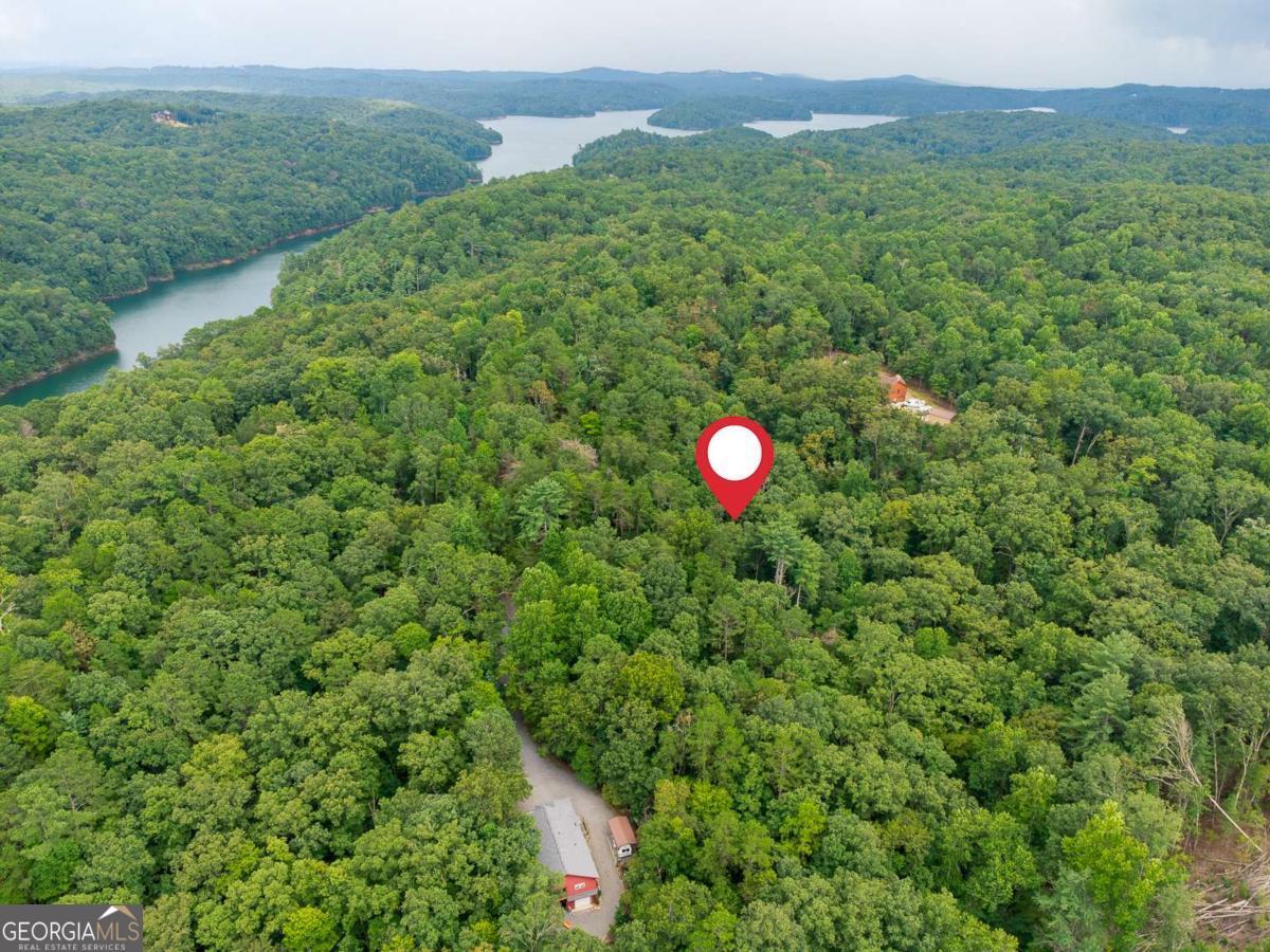 Nestled in the scenic North Georgia mountains, this 1.59-acre residential lot offers the perfect opportunity to build your dream home. Located near Carters Lake, the property provides breathtaking views and a peaceful setting surrounded by nature. With beautiful homes nearby and no HOA, you'll enjoy both community charm and the freedom to design your own vision. Just minutes from downtown Ellijay, you'll have easy access to local shops, restaurants, wineries, orchards, and endless outdoor recreation-hiking, fishing, and boating are all at your fingertips. The Carters Lake Boat Ramp is less than 10 minutes from the property. Whether you're looking to build a private retreat, a full-time residence, or a mountain getaway, this lot combines tranquility with convenience in one of Georgia's most beloved destinations.