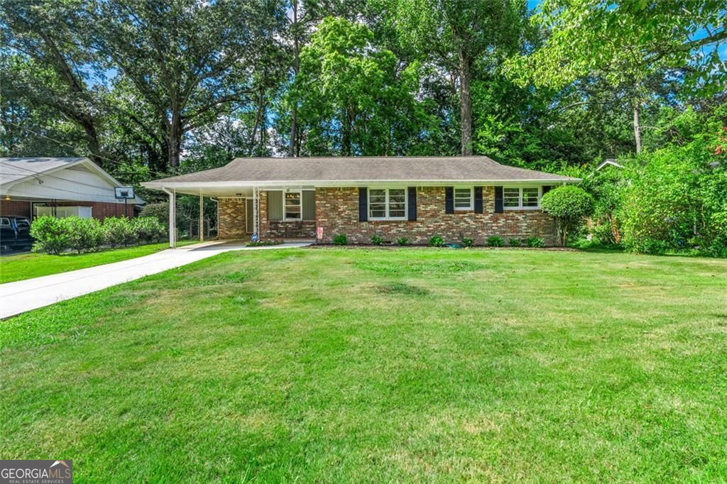 Nestled in the desirable Lindmoor Woods subdivision, this inviting single-story ranch boasts a brand-new kitchen featuring a stylish island, crisp white cabinetry, and new flooring that enhances the fresh, open space. The three comfortable bedrooms provide ample space for family and guests, complemented by a full bathroom and a convenient half bath. The level backyard provides ample room for outdoor fun and relaxation, perfect for family gatherings or gardening enthusiasts. Greet neighbors from your front porch and the brand new driveway makes parking a breeze. This home is just steps from the Lindmoor Woods Swim and Tennis club. Easy access to Decatur, local shopping, and the highly anticipated Lulah Hills development!