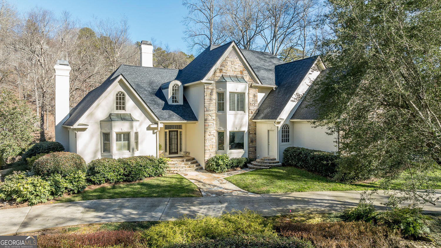 Extraordinary Riverfront Retreat in the Coveted Rivergate Community! Discover unparalleled beauty and tranquility in this stunning riverfront estate, perfectly situated on a private cul-de-sac lot in the prestigious Rivergate neighborhood. Boasting breathtaking, unobstructed views of the Chattahoochee River from nearly every room on the main level, this home is a rare gem that seamlessly blends luxurious living with the serenity of nature. Step into the elegant two-story entry foyer, where natural light pours in and sets the tone for the grandeur that lies beyond. The vaulted and beamed great room is nothing short of spectacular, featuring an impressive stacked-stone fireplace and dramatic arched feature windows that frame the mesmerizing river views. The heart of this home is the gourmet chef's kitchen, a perfect fusion of style and functionality. Highlights include custom-stained cabinetry, a breakfast bar, stainless steel appliances (gas cooktop, double ovens, built-in Sub-Zero refrigerator, and two dishwashers), a center island, solid surface countertops, a coffee bar/Butler's pantry, and a cozy desk nook. The adjoining vaulted breakfast area and family room, both bathed in natural light, continue the theme of unparalleled views, with direct access to the stone patio and deck overlooking the private backyard oasis and the river. Retreat to the luxurious main-level owner's suite, a private haven featuring a sitting room with tongue-and-groove vaulted ceilings and direct access to the backyard. The spa-like bathroom offers a freestanding soaking tub, an oversized walk-in shower, double vanities, and a large walk-in closet. Upstairs, you'll find four spacious secondary bedrooms. Two share a Jack-and-Jill bath, while two offer ensuite bathrooms, including one with private stair access from the garage, creating a perfect guest or in-law suite. Practical luxury meets thoughtful design with the addition of a three-car garage, offering additional ample storage and an extra refrigerator. This home's meticulous maintenance, hardwood floors on the main level, and thoughtful details throughout ensure it is truly move-in ready. Located in the sought-after Sandy Springs/Dunwoody area, this extraordinary home combines the serenity of riverside living with convenient access to premier shopping, dining, top-rated private and public schools, and recreational destinations, including Dunwoody Country Club and Golf Course. Don't miss this once-in-a-lifetime opportunity to own a home where every day feels like a retreat. Come experience the magic of riverfront living!