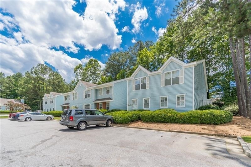 Move right in or renovate and create your perfectly personalized space! Ground floor/stepless condo in the heart of Alpharetta! Larger floorplan -- one of the few that has an enclosed sunroom (which includes a huge storage closet) for expanded living space and to bring the outdoors in! Spacious great room with gas log fireplace and an open concept floorplan including dining area and kitchen that is great for entertaining! Owner's bedroom features an en suite bathroom and large walk-in closet, and secondary/guest bedroom has two closets & private access to the hall bath. Laundry is in unit in a large hall closet -- washer and dryer included! Additional coat closet provides even more storage. Enjoy a wooded view from the sunroom for added privacy Close to the shopping and dining of Alpharetta Square, as well as all that Windward parkway has to offer and easy access to GA-400. Complex includes pool and tennis for a great, low monthly HOA. Make this great condo your home!