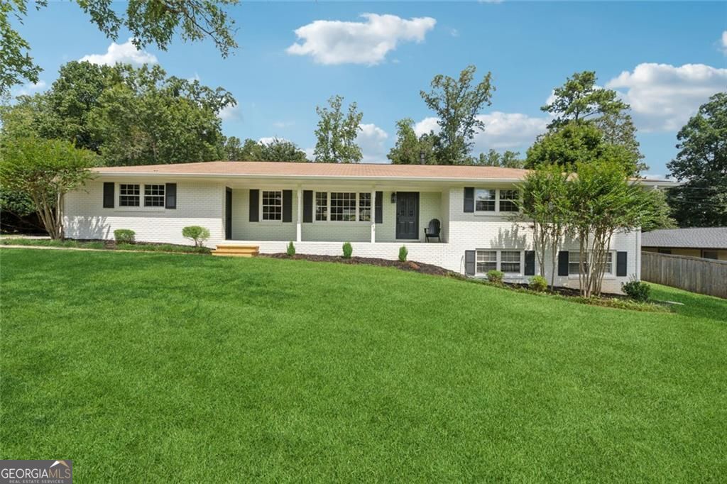 **MULTIPLE OFFERS RECEIVED** Calling for Highest and Best Offers by Monday, 9/8 at 12pm. Say hello to your new home with a private backyard oasis just minutes from 285 and Smyrna! Fully renovated in 2025, this 4-bedroom, 2.5-bath, 4-sided brick ranch features an open layout with spacious living and dining areas open to the updated kitchen with new cabinets, granite counters, and stainless appliances. The 4th bedroom is ideal for a home office, study, or playroom just off the main living area. Brand-new LVP flooring runs throughout every room! Walk out to the covered patio with a built-in gas grill and hood, only steps away from your private in-ground pool. The large lot is configured into three separately fenced spaces: a wood privacy-fenced pool area, a side yard with a storage shed, and another side yard to the left with direct driveway access. Perfect setup for entertaining while also having separate spaces for pets and play! A 2-car garage and large driveway offer plenty of parking for pool parties and cookouts. The full unfinished basement adds endless potential-storage, rec room, home business, or gym-with a 3rd garage bay perfect for a workshop, mower and lawn equipment, motorcycle, and more. All just 10 minutes to I-285 at West Village and 12 minutes to Downtown Smyrna!