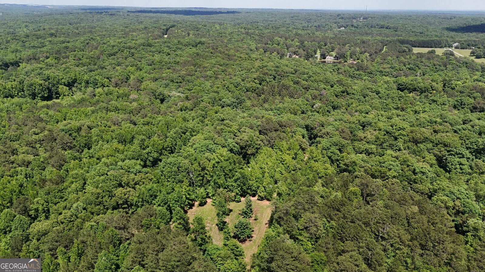 Wonderful Opportunity To Own A Little Slice Of Heaven Just 4 Miles From The Interstate. This 11+ Acre Property Sits Secluded, Offering All The Privacy You Could Hope For, While Only A Short Drive To Everything You Need. Zoned Residential, This Property Boasts A Gentle, Level Topography, Cleared Space With The Potential For Multiple Homesites, Utilities Access, Multiple Out-Buildings, Hardwoods, And Access To Mobley Creek That Runs Across The Backside Of The Property. There Is Also A Small Home On The Property That Can Be Used As A Hunting Cabin, Weekend Getaway, Or Temporary Living Space While You Build Your Dream Home. This Is The Perfect Opportunity For Those Looking To Get Away From It All, While Being Close Enough To Everything You Need.