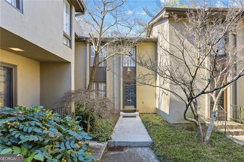Incredible opportunity in The Ivy's in the heart of North Buckhead! This home is located in an ideal quiet location in the neighborhood and backs up to common area greenspace. Features include hardwood floors, built in bookshelves, fireplace, tons of storage space, and an open floorplan practical for everyday living and entertaining. This home offers two bedrooms, two full bathrooms, a powder room, flexible terrace level space for media room or office and a fully fenced back patio space. The Ivy's is located in a highly desired neighborhood convenient to Chastain Park, Buckhead and Brookhaven. Enjoy the luxuries of intown living and stroll to local neighborhood favorites such as Bar Taco, Superica, Hals Steakhouse, Cava and so much more! Social neighborhood with a community pool, newly renovated tennis courts, green space and dog walking stations.