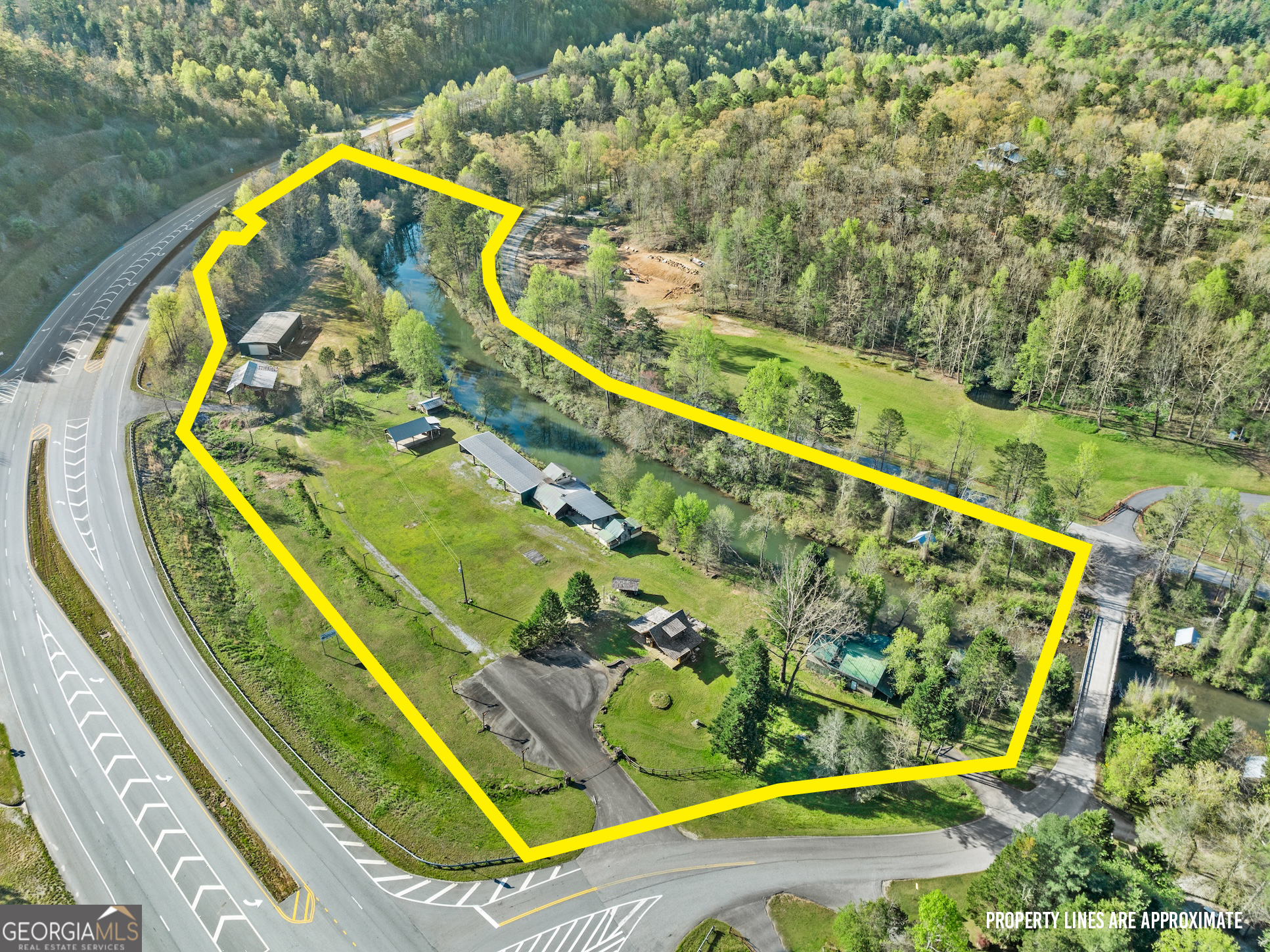 Remarkable opportunity in ever-growing Rabun County, 10.42+/- flat acres on both sides of the Tallulah River with over 2,500 feet of river frontage! Multiple structures and billboard on property. DOT has two cut-ins from 441 for multiple access points if desired.