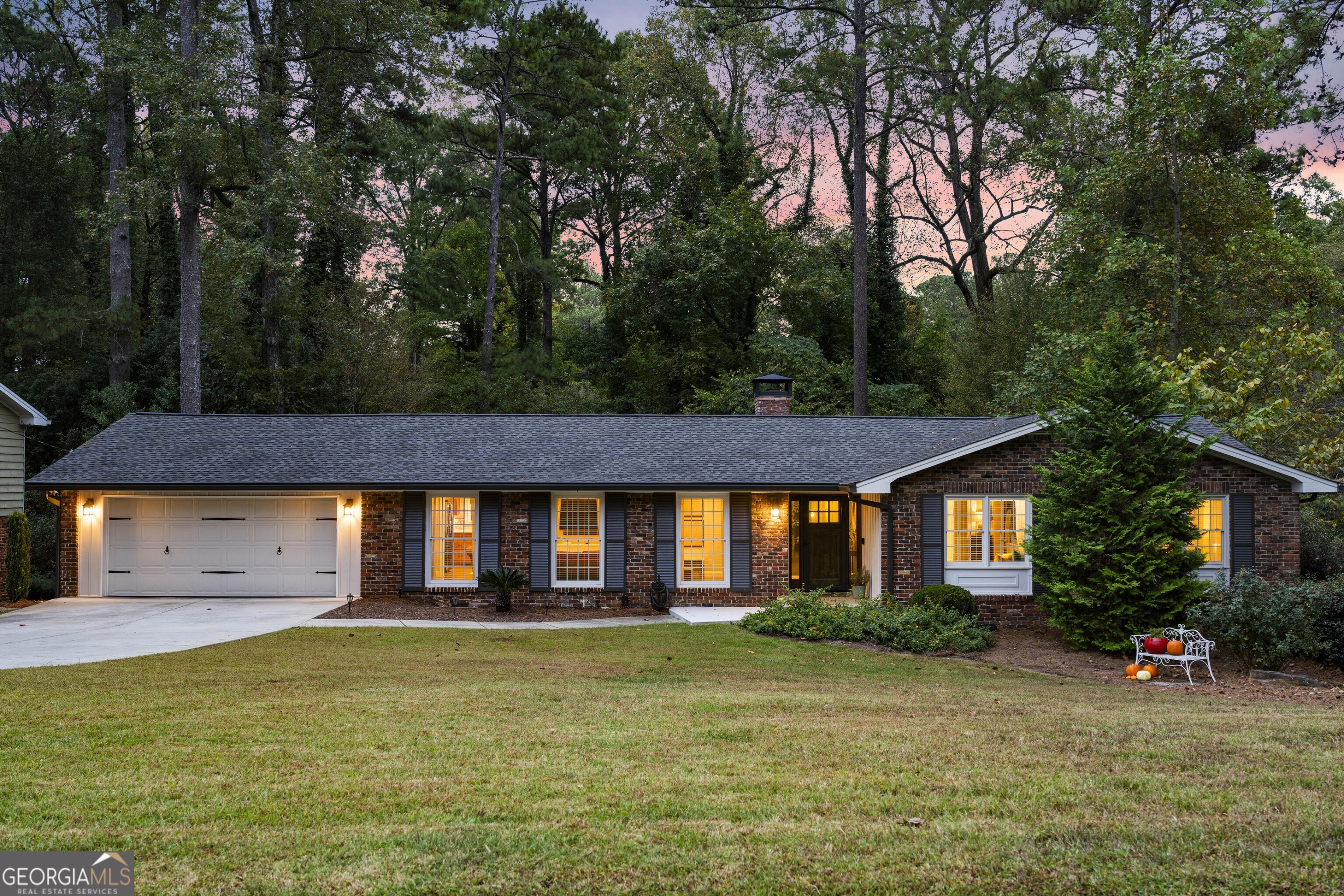 This home may appear to be a classic ranch-but step inside, and you will discover a delightful surprise. The inviting floor plan strikes the perfect balance between openness and coziness, creating an easy flow for both everyday living and entertaining. The chef's kitchen features custom wood cabinetry, new quartz countertops, a stylish backsplash, and updated hardware-all with a view to the comfortable family room. A charming fireplace anchors the space, offering warmth and ambiance during cool fall and spring evenings. A screened porch off the kitchen and dining area provides a serene view of the surrounding woods making this an ideal spot to enjoy morning coffee or host friends for a relaxed evening. Renovated bathrooms bring a touch of modern luxury, while rich hardwood floors create a warm, cohesive feel throughout this home. Expansive terrace level, filled with natural light, flows through double French doors to another deck and extends your living options with a flexible layout. The convenient kitchenette and full bathroom create a superb space for a private suite when guests, friends or extended family visit. Nestled among mature trees, this home feels like a private retreat yet minutes from premier dining, boutique shopping, and major highways. In an exceptionally friendly and established community, you will enjoy both tranquility and convenience-a rare combination that defines modern luxury living.