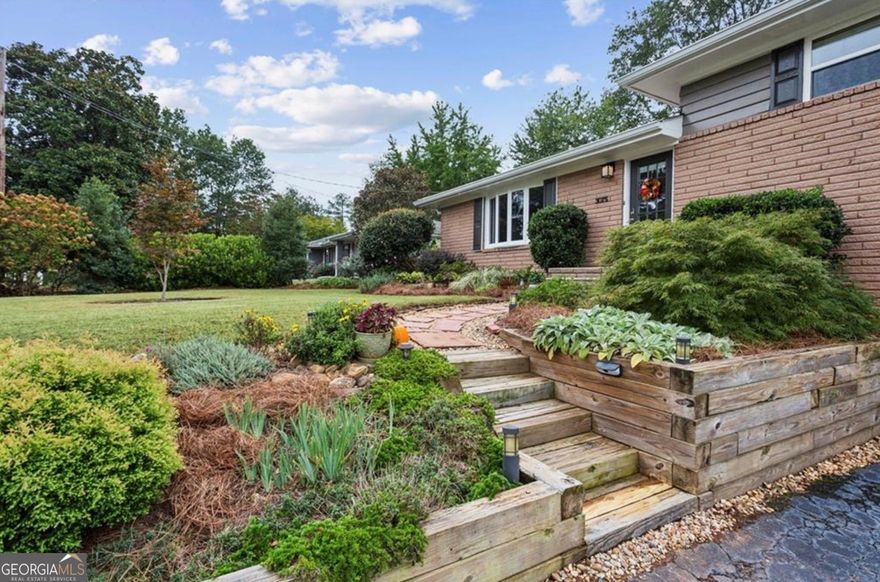 Discover your slice of nature in this beautifully updated split-level home, ideally located on a quiet street in East Marietta with no HOA. The thoughtfully designed yard is a true retreat, featuring thriving pollinator garden beds filled with colorful ornamentals that attract butterflies, hummingbirds, and a wide variety of native birds. Enjoy outdoor living at its finest on the spacious deck with a screened and covered gazebo offering an expansive view of the backyard. Gardeners will love the 12'x36' vegetable garden complete with perennial asparagus, mature blueberry bushes, fig tree, and a variety of herbs.  Inside, this well-maintained home offers 3 bedrooms and 2 full bathrooms with hardwood floors throughout. The updated kitchen showcases new white quartz countertops, a large sink, and a new refrigerator-all added in 2025-along with refinished original hardwoods and tile flooring. Both bathrooms have been tastefully updated, and the home features double-pane vinyl windows, ensuring comfort and energy efficiency. Major updates include a new electrical panel in 2025, a new roof, and fresh exterior paint in 2024.  The partial basement includes a laundry room and connects to a large garage that offers abundant storage and workspace. Conveniently located within walking distance to an excellent elementary school and surrounded by several young families, this home is perfect for those seeking community and connection.  Well-loved and carefully maintained homes like this are a rare find-don't miss your opportunity to make it yours!