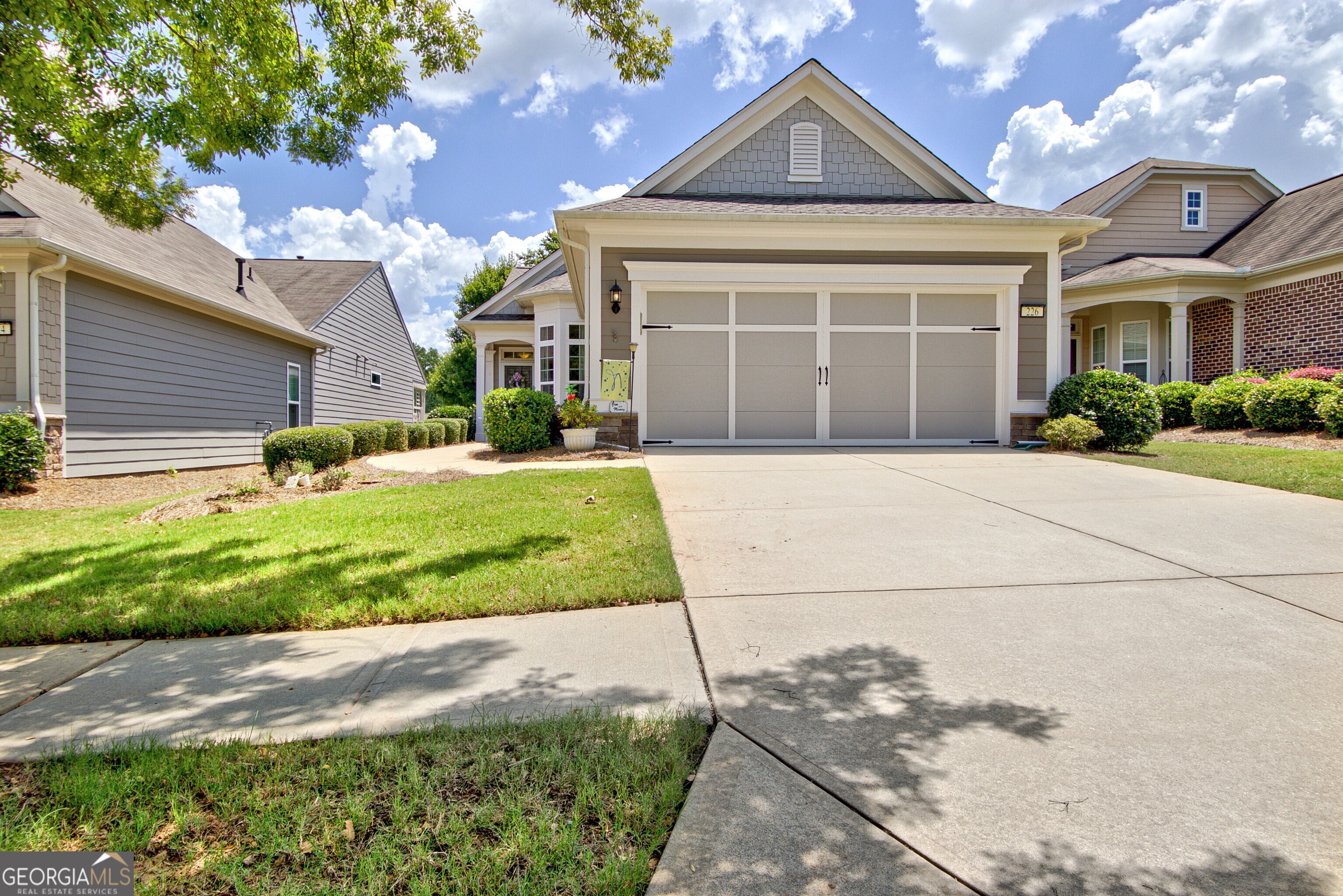 YOUR SEARCH IS OVER! This Attractive, sought-after 3 bedroom plan, the GRAY MIST can be yours now. Nestled in the Heart of Sun City Peachtree, this home located at 226 English Ivy Drive offers an excellent living experience and is the epitome of comfort surrounded by fun, loving, caring neighbors. This home offers wonderful upgrades and boasts a spacious open floor design that is perfect for entertaining family and friends. As you walk through the front door into the foyer, your eyes take you from the front of the home to the back. The inviting chef's kitchen off to the right of the foyer offers a built-in desk for all your cook books and computer, plenty of upgraded cabinets, stainless steel appliances, granite countertops, under cabinet lighting, sun-lite Breakfast Knook for your morning coffee and a pass through to the dining room. This home features 3 bedrooms: the Master bedroom embellishments include a trey ceiling, an ensuite bathroom with a walk-in tiled shower, double vanities and cultured marble counterntops, the guest bedroom is a perfect retreat for your guests and the 3rd bedroom can also be used as an additional flex room for office or incredible storge area. The open living areas are saturated with natural light which enhances the beauty of the stunning wood flooring throughtout the Dining room and Great room. From the great room you can step outside to a large patio with designer flooring and a gas outlet for grilling; Soothing area for enjoying the outside breezes and watching and listening to God's creatures. The home also has the following outstanding amenities: new 25 year roof, freshly painted exterior and trim, 4 foot extended garage with pull down attic stairs for storage, epoxy flooring and utility sink. Come Home to the Bright and Airy Gray Mist. You will Fall In Love!