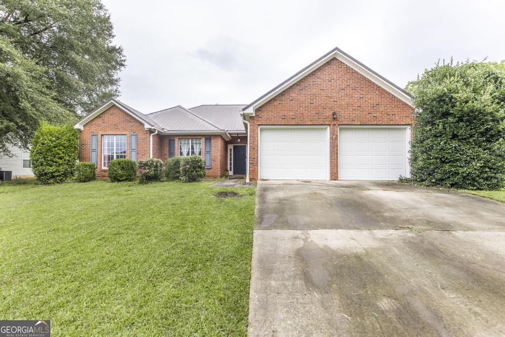 STOP SCROLLING! Beautiful 3BR/2BA four-sides brick home in Harper's Ridge. Step inside to a welcoming foyer that opens to a cozy living room with a gas fireplace. The dining room is perfect for large gatherings, and the kitchen offers abundant cabinetry, a breakfast bar, pantry, eat-in space, and tiled backsplash. The primary suite features a trey ceiling, walk-in closet, and a spacious bath with dual vanities, a jetted tub, and a separate shower. Added value: a durable metal roof for lasting protection and savings, plus termite coverage already in place through September 2026. The backyard is your own private retreat, featuring a covered wraparound screened-in porch overlooking an in-ground pool-perfect for entertaining or simply cooling off on a hot Georgia day. Schedule your showing today and see why this Harper's Ridge home is the one.