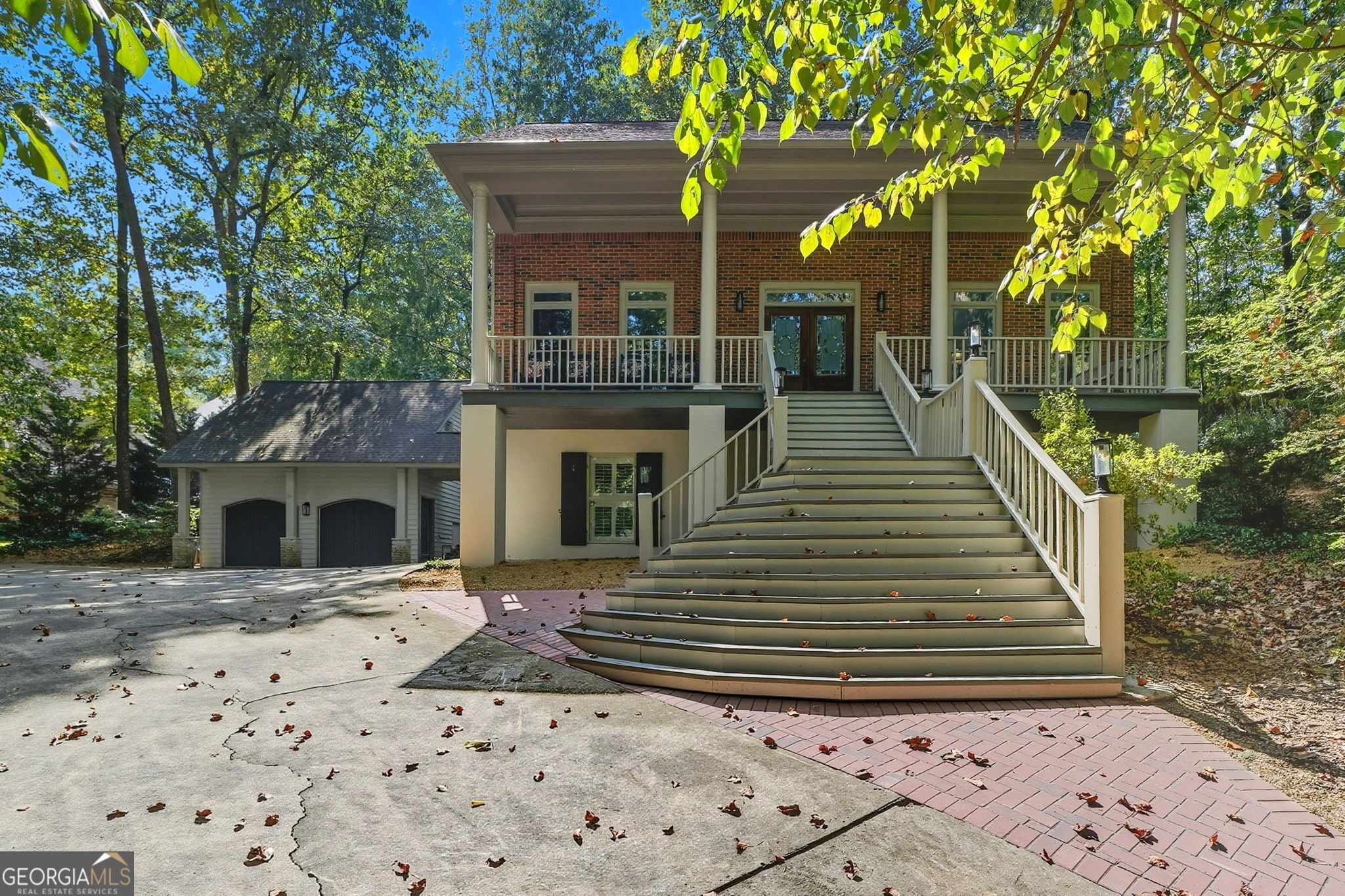 Unique 2-Story Home on a Private almost acre Wooded Oasis in sought after Roswell. Tucked away at the end of a long driveway, this beautifully maintained home offers privacy, charm, and plenty of upgrades. Step inside a spacious foyer that opens to a formal dining room and an oversized family room with a wall of custom built-in bookcases. The main level features refinished hardwood floors, while the upstairs boasts new hardwoods and the finished basement includes new durable LVP flooring. The updated kitchen is a chef's delight with white cabinetry, granite countertops, kitchen bar area, double ovens, and a sunny eat-in breakfast nook. The owner's suite is a true retreat with its own fireplace, walk-in closet, and spa-like bath with an additional walk-in closet and linen closet. Upstairs also includes a convenient laundry room and two secondary bedrooms connected by a Jack & Jill bath. The finished basement provides flexible living space with a media room, bedroom, full bath, and storage room. A garage apartment-ideal for future finishing or use as storage-adds even more potential. Enjoy outdoor living on the new brick patio surrounded by mature trees, with fresh exterior paint, new front entry steps, 2 newer HVAC's (replaced in 2022), and a newer roof replaced in 2016 with 30-year architectural shingles for peace of mind. Neutral paint throughout makes this home truly move-in ready. Located in the sought-after Roswell High School district and just minutes from shopping, dining, and everyday conveniences-this property offers both lifestyle and location!