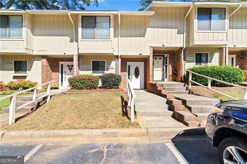 Welcome to a beautiful well-maintained 2 bedroom, 2.5-bath townhome located in the heart of Marietta that offers a perfect blend of comfort and convenience, with many amazing features! Updated luxury laminate flooring, fresh paint and new fixtures! The kitchen is equipped with granite countertops, stainless steel appliances, big pantry and plenty of cabinet space. It opens seamlessly into the two-story dining room with an open view of the upstairs, adding to the home's airy and spacious feel. The living room is warm and inviting with a cozy fireplace perfect for relaxing evenings or entertaining guests. The upper level features two bedrooms, each with a private bathroom and a spacious closet, with the master bedroom access to the balcony. New Washer and dryer included. This friendly community boasts fantastic amenities including a swimming pool, tennis courts, and dog-friendly spaces. It offers a perfect mix of comfort, convenience, and outdoor enjoyment. With only 5 minutes drive to I-75 and minutes from the Truist Park, with various shopping and restaurant options. HOA covers the exterior building, roof, grounds, maintenance, trash, water, swim/clubhouse, and common area landscaping you can enjoy worry-free living. The home comes with 2 assigned parking spaces right out front and there is plenty of guest parking. Come and see all that this townhome has to offer before it's gone!