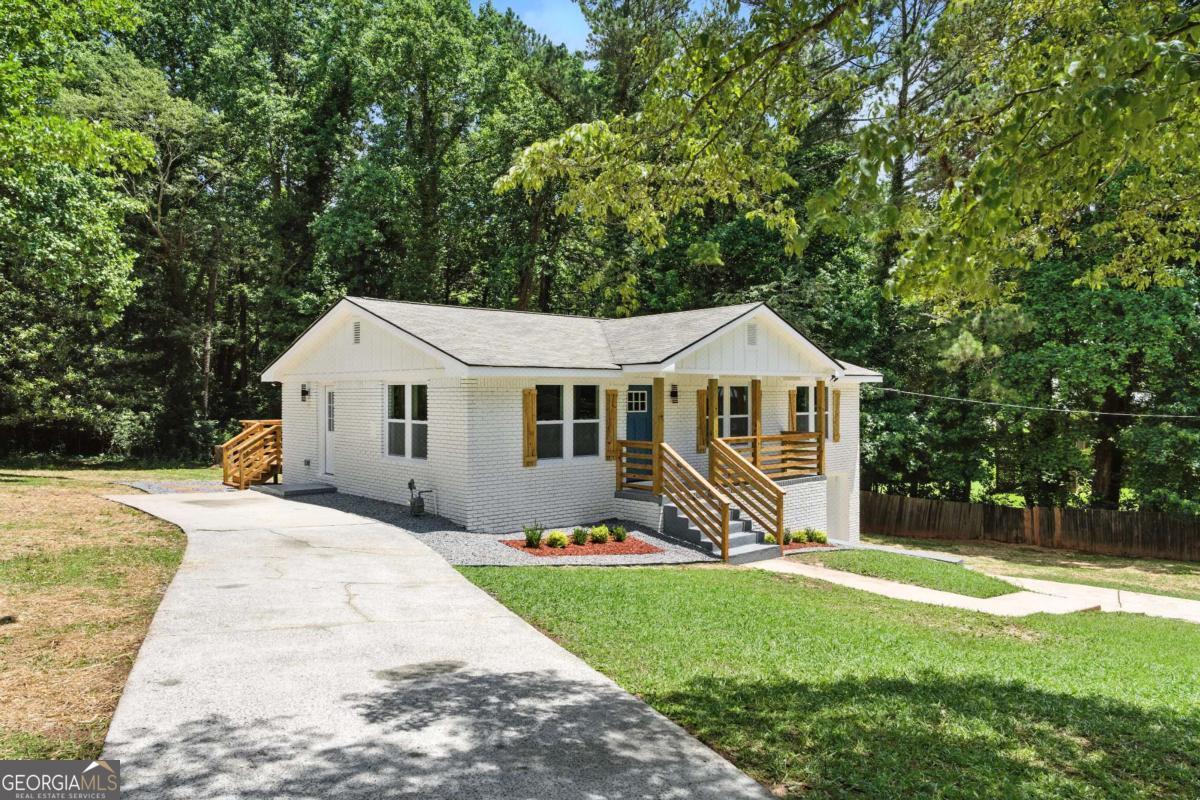Fully Renovated Traditional Gem in Prime Marietta Location! Welcome to 3013 Michael Dr SW - the perfect blend of comfort, style, and modern elegance! This completely renovated 4-bedroom, 2-bathroom home is a true showstopper, thoughtfully updated with today's most sought-after features. Step inside to discover an open and spacious floor plan adorned with luxury vinyl plank (LVP) flooring, custom accent walls, and sleek black finishes throughout. The heart of the home is the modern chef's kitchen, boasting stunning granite countertops, a waterfall island, crisp cabinetry, and stylish fixtures - ideal for both entertaining and everyday living. Both bathrooms have been beautifully updated with modern touches and quality finishes to create a spa-like experience. Flooded with natural light, this home feels airy and inviting from every angle. Enjoy the outdoors in your private backyard oasis, complete with a deck perfect for gatherings and professional landscaping that enhances the home's charming curb appeal. Nestled in a quiet, well-established neighborhood with no HOA, this home offers easy access to Smyrna, The Battery, Truist Park, and I-75, placing you just minutes from Downtown Marietta and a short drive to Atlanta.
