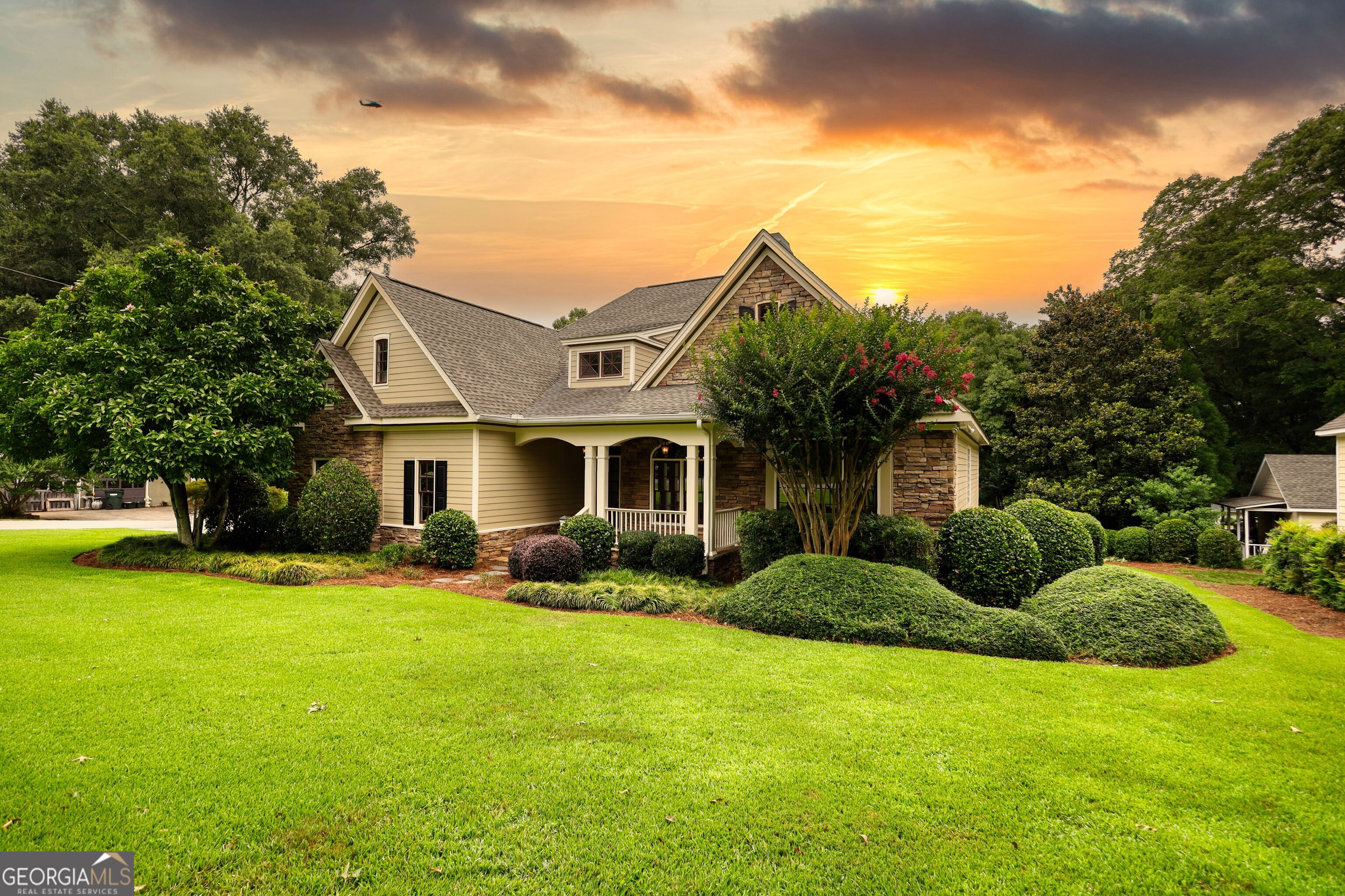 Custom built home with vaulted/trayed ceilings and hardwood floors in desirable, downtown Madison. Walking distance to shops, city park, pickleball/tennis courts, and all this with a front porch view of an established pecan orchard. This home offers a master on main with walkout access to the rear deck, 2nd bedroom and office (or 3rd bedroom) with full bath on main, finished bonus room above the garage with a full bath, mud room/laundry room, breakfast nook and formal dining room. Fully remodeled kitchen and master bath with soaker tub, custom tile/frameless shower, and his/her walk-in closets.