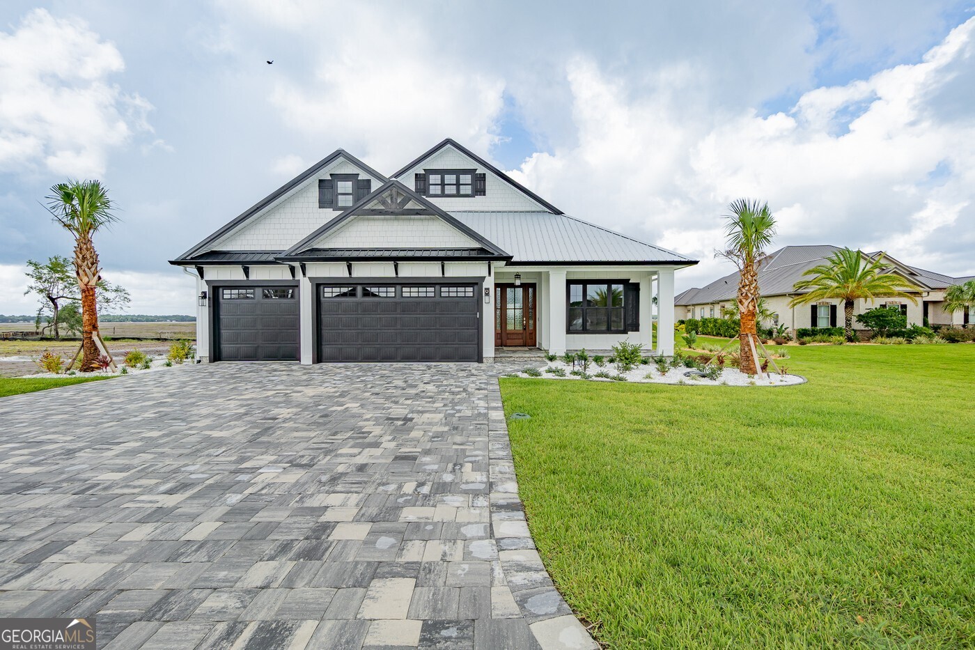 Experience coastal elegance in this brand-new, marsh front home by Sawyer and Associates, located in the desirable gated community of Fiddler's Cove. Stunning marsh views greet you immediately upon entering this open-concept residence, designed for effortless entertaining and relaxation. The gourmet kitchen is a chef's dream, featuring stainless steel appliances, custom cabinetry, and quartz countertops. Retreat to the luxurious master suite with its spa-like bath and spacious walk-in closet. Three additional bedrooms and two full baths complete this thoughtfully designed home. Outdoors, the expansive patio invites you to unwind and soak in the spectacular marsh scenery. The Fiddler's Cove community enhances your lifestyle with fantastic amenities such as a swimming pool, fitness center, and inclusive lawn care. This is your opportunity to own a new construction home in a prime coastal location. Contact us now for a private tour.